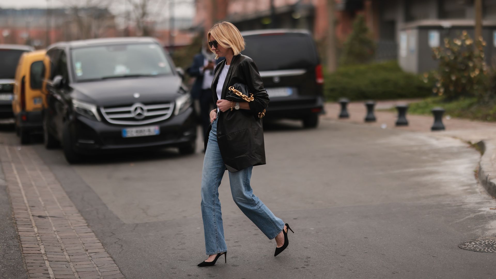 A woman wears straight-leg jeans during Paris fashion week.