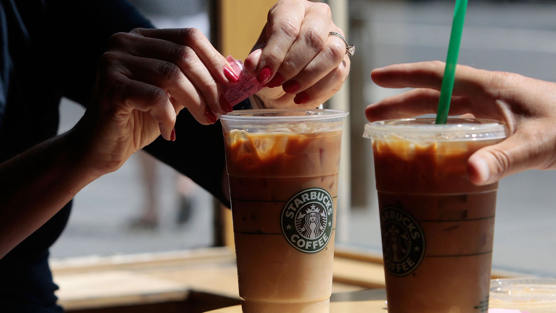 Two people prepare cold Starbucks drinks