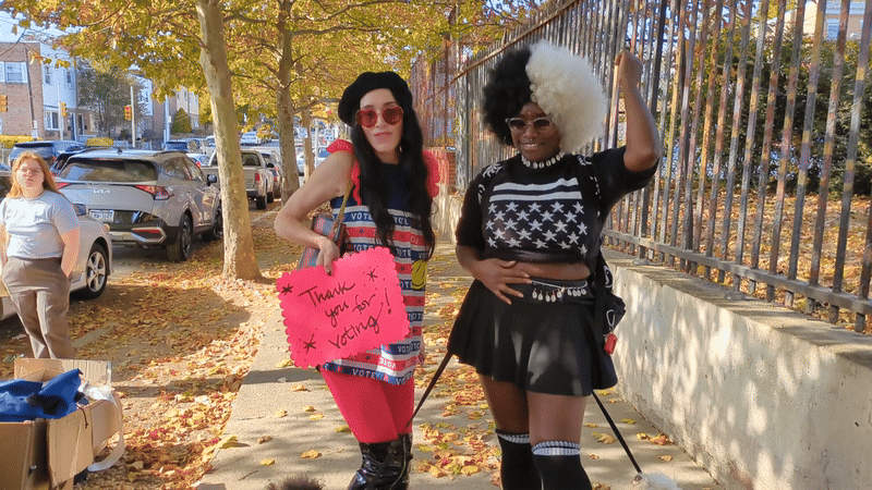Sarah Sophie Flicker, left, and Leighdy Morris listen to a pop-up performance of Snacktime at the Penrose Recreation Center on Tuesday during a Joy To The Polls event.  