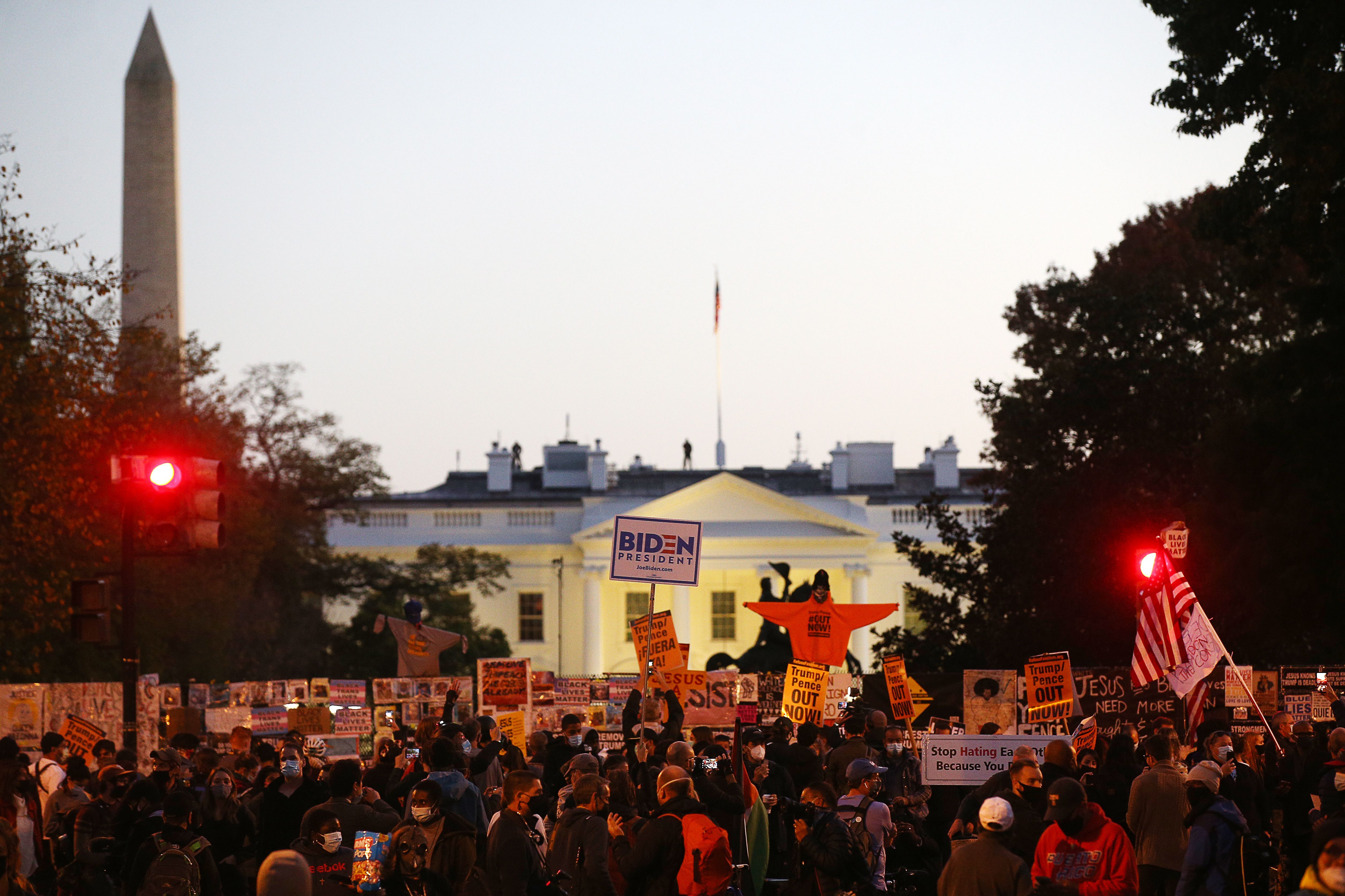 Supporters of Democratic presidential nominee Joe Biden gather near the White House on Tuesday evening. 