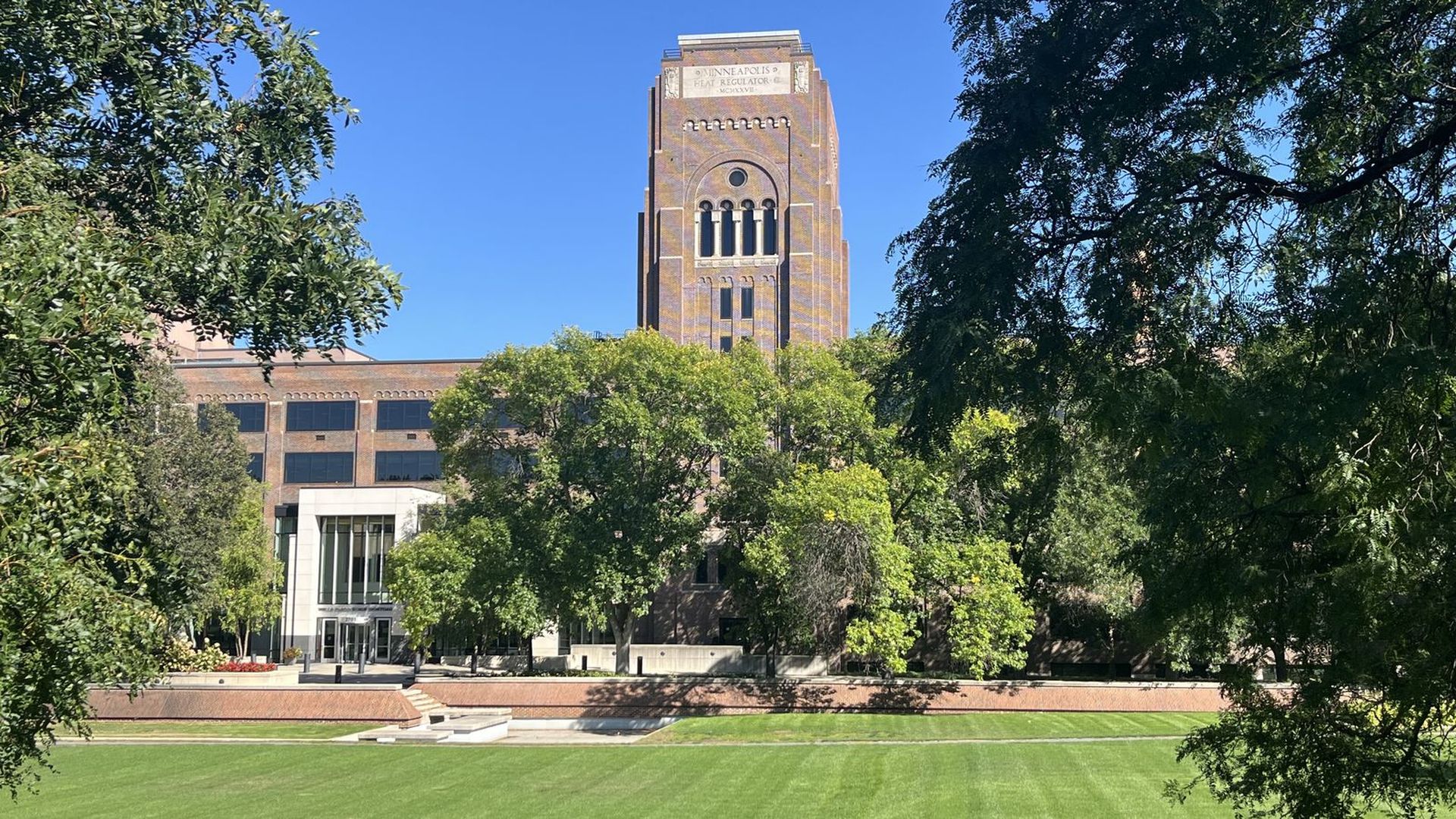 A photo of the Wells Fargo campus with a green lawn in foreground