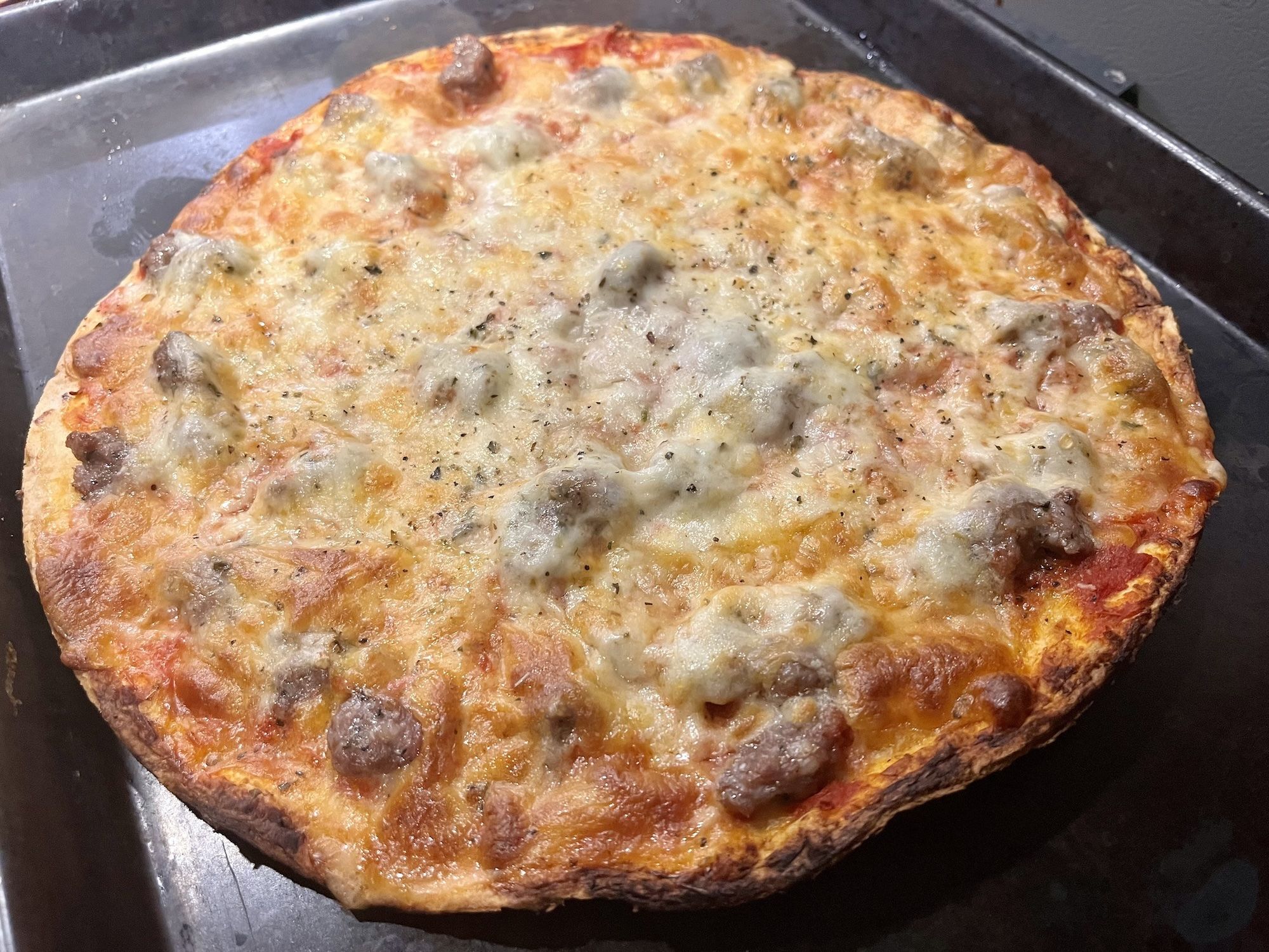 Thin crust sausage pizza.