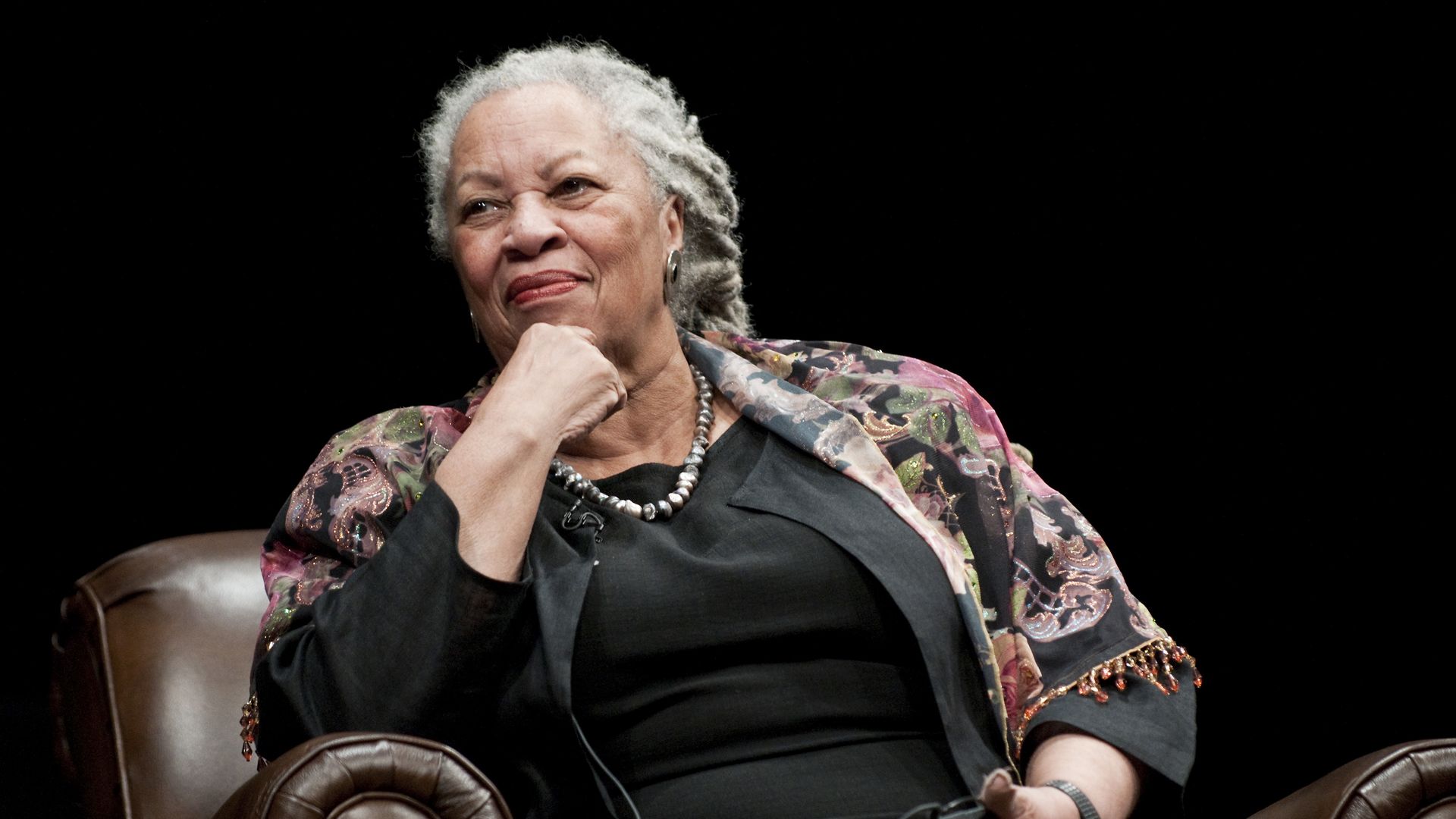 Author Toni Morrison sits with her chin resting on her closed fist