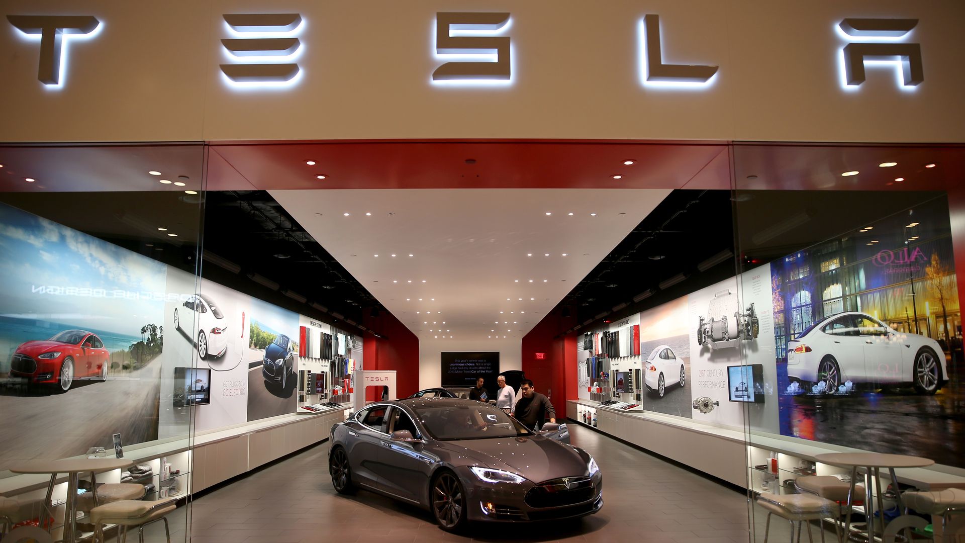 People look at a Tesla Motors vehicle.