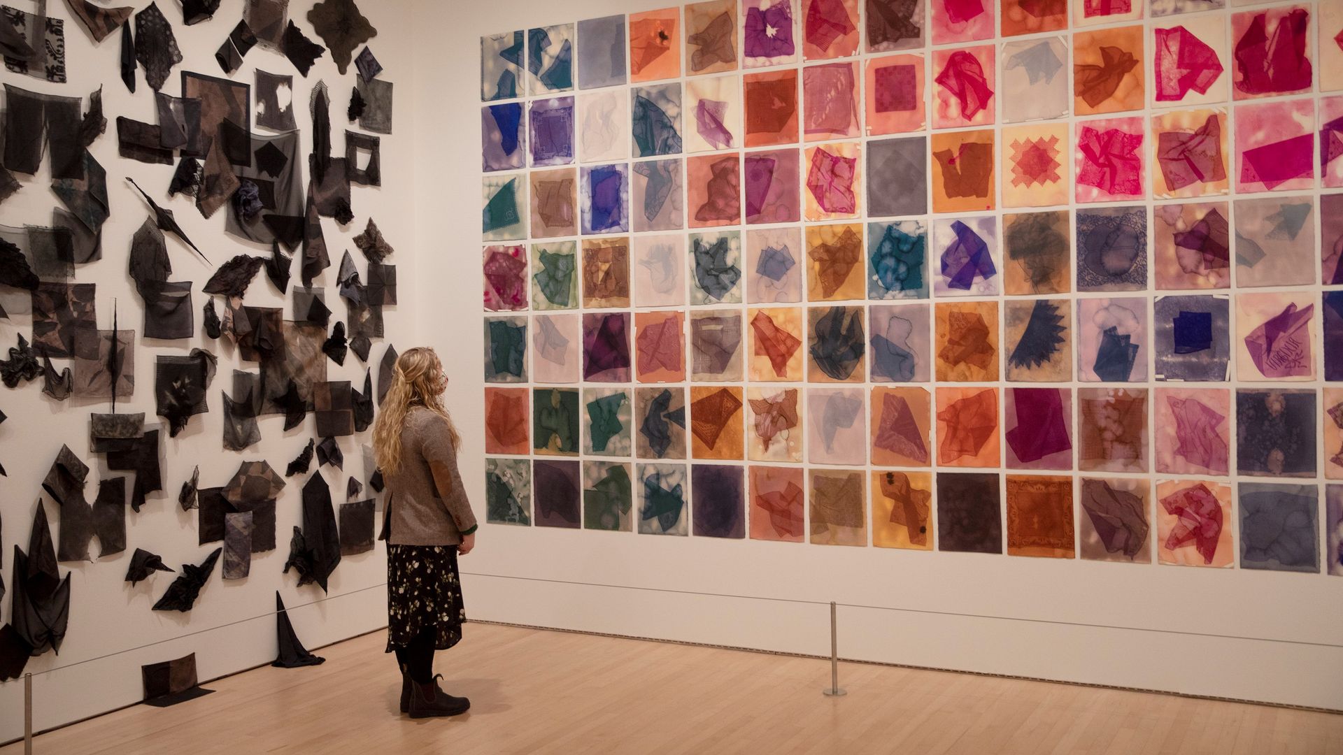 Photo of a person gazing upon an artwork comprised of colorful squares