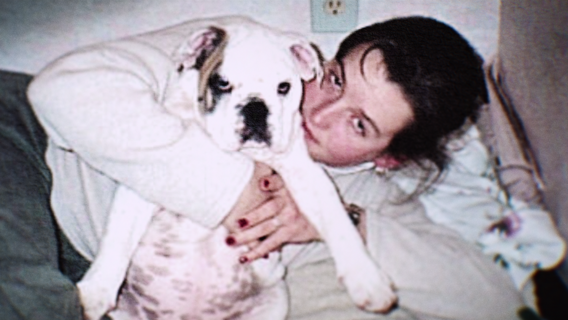 A woman hugging a dog 