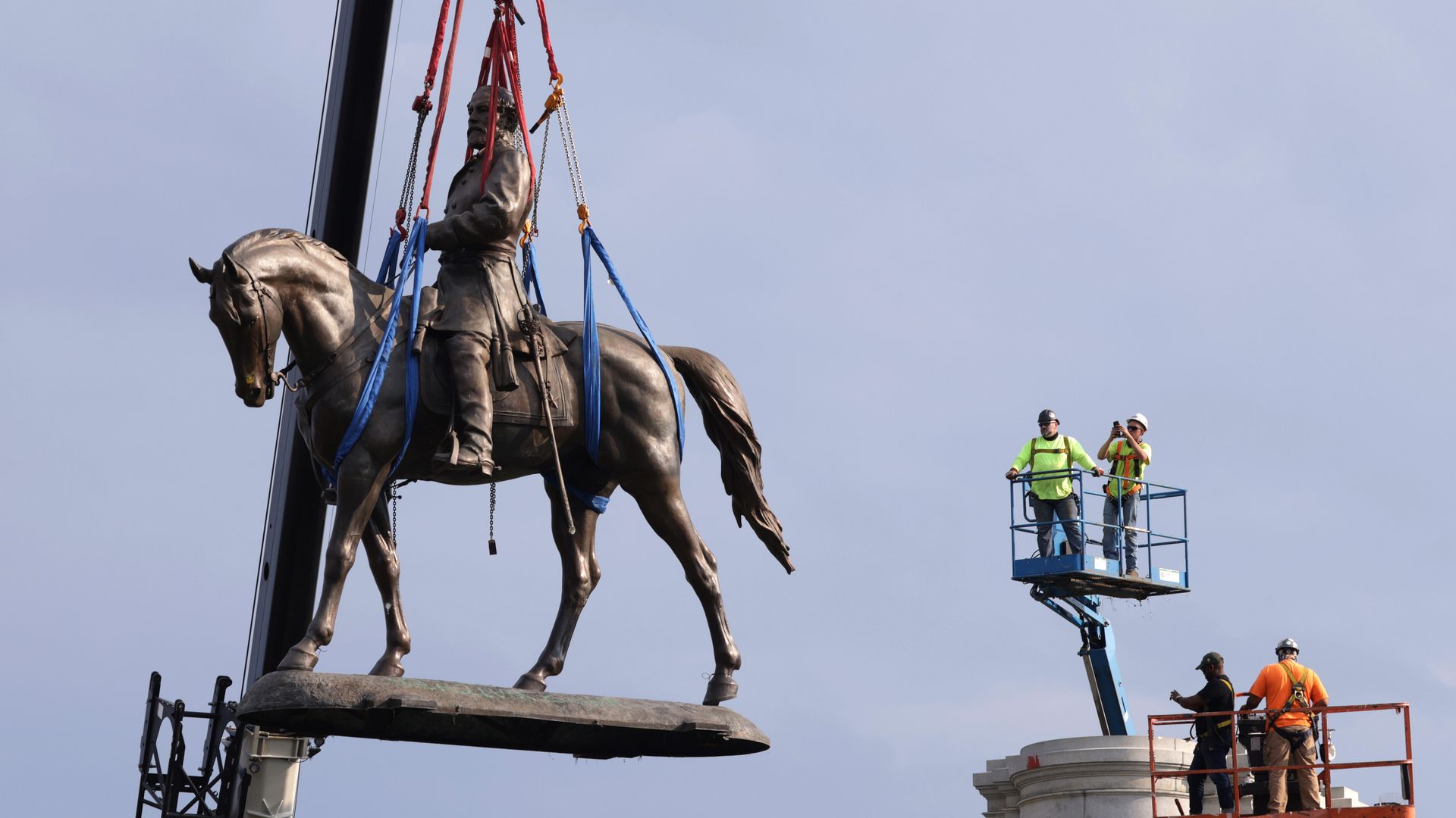 The statue of Robert E. Lee is lowered from its pedestal at Robert E. Lee Memorial during a removal September 8, 2021 in Richmond, Virginia.