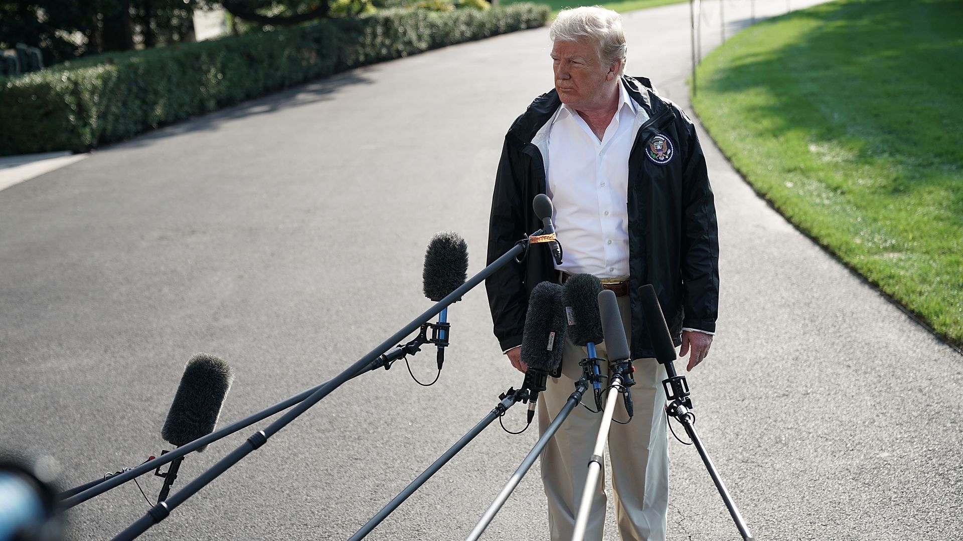 President Trump speaks with reporters outside the White House.