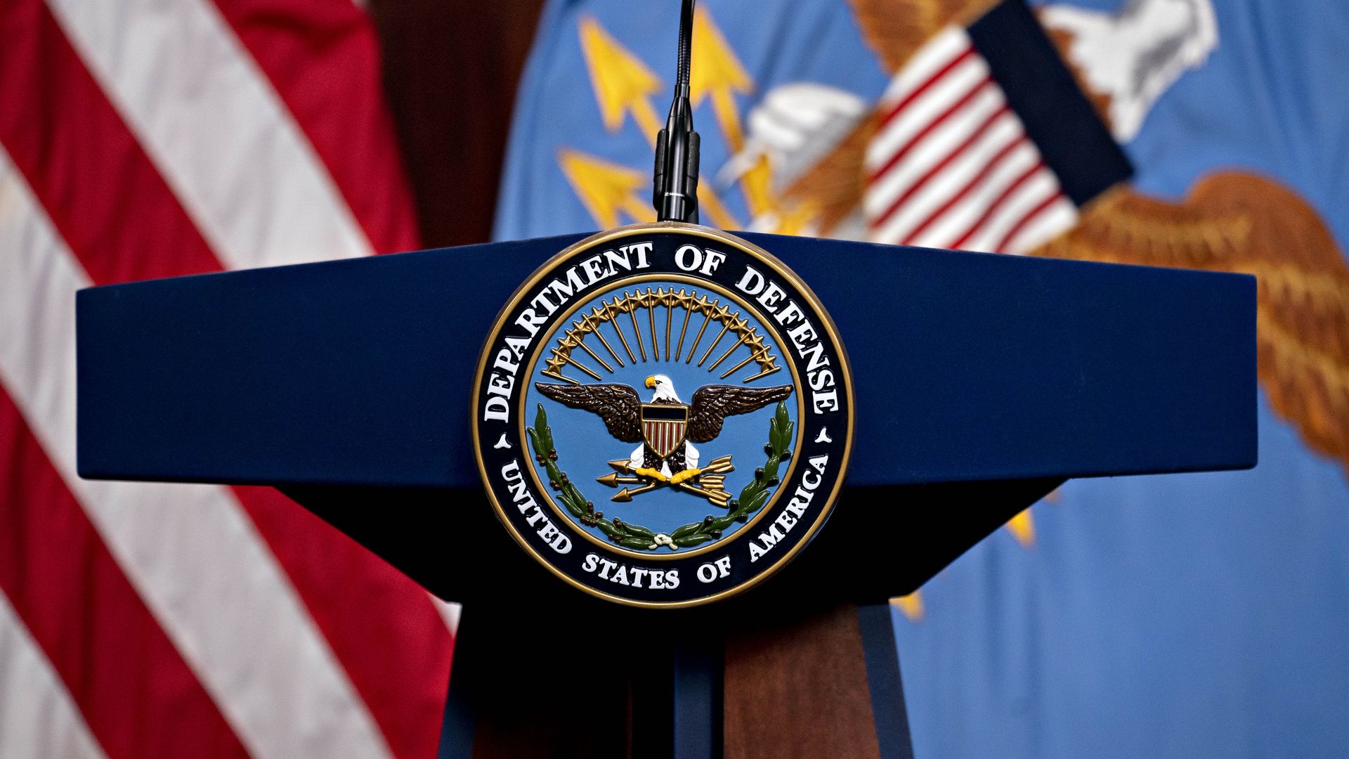Photo of a podium with the Defense Department logo on it