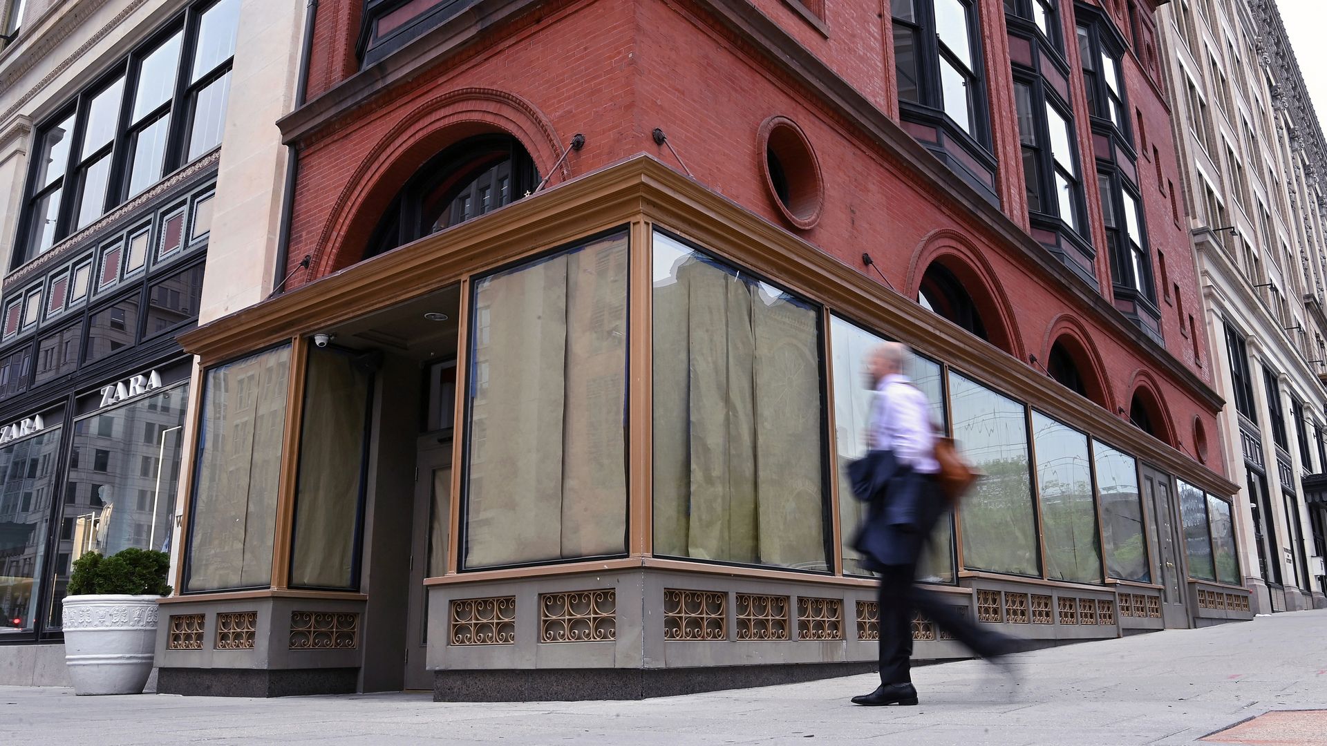 A man walks by an empty storefront in downtown D.C.