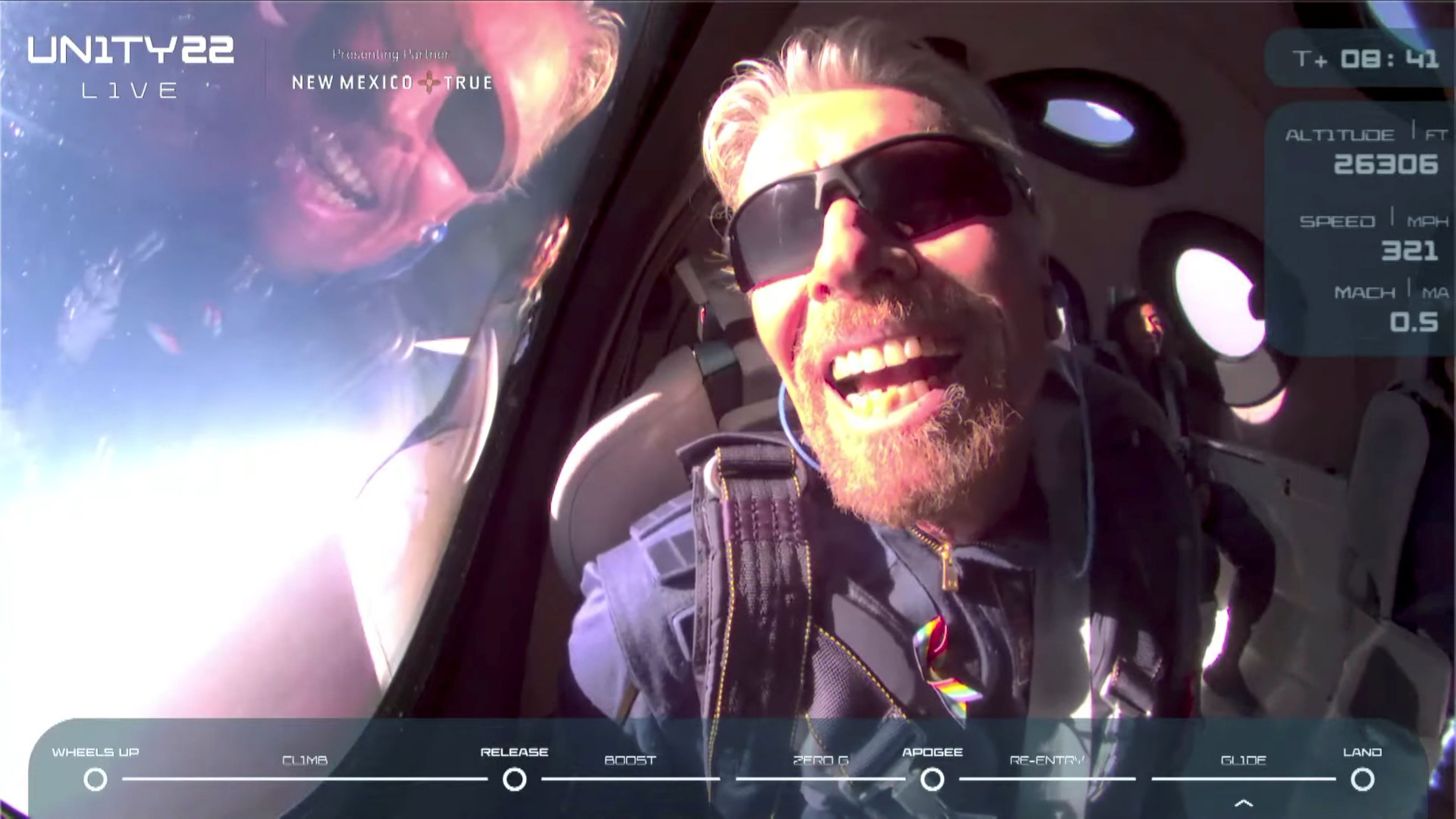 Richard Branson reacts on board Virgin Galactic's passenger rocket plane VSS Unity after reaching the edge of space.