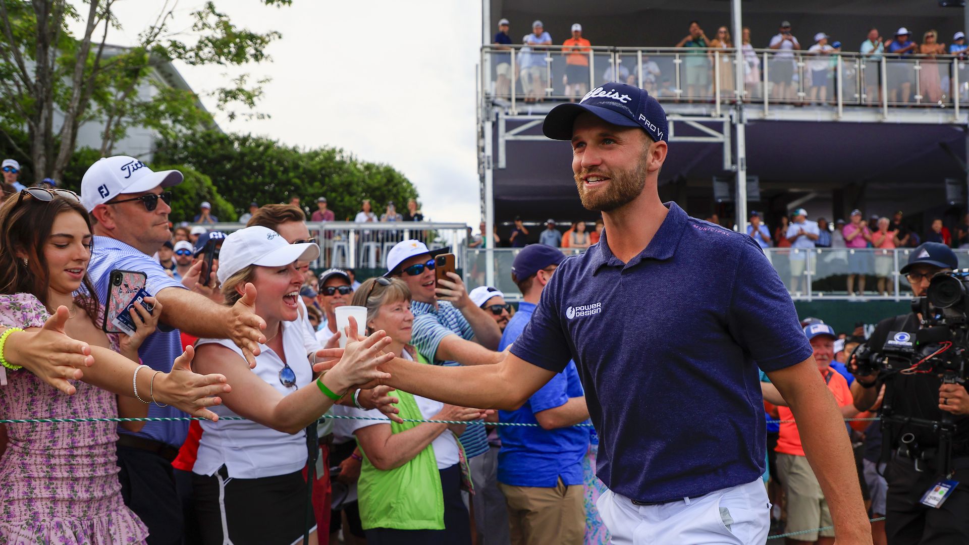Clark high fives fans as he walks the the Quail Hollow Club course at the Wells Fargo Championship.