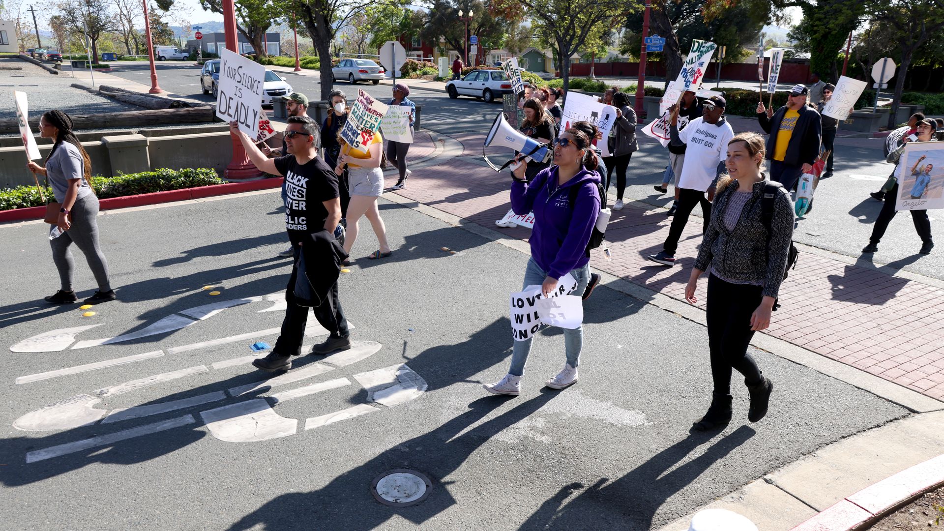 Community members march from Antioch police headquarters to City Hall in Antioch, Calif., on Tuesday, April 18.