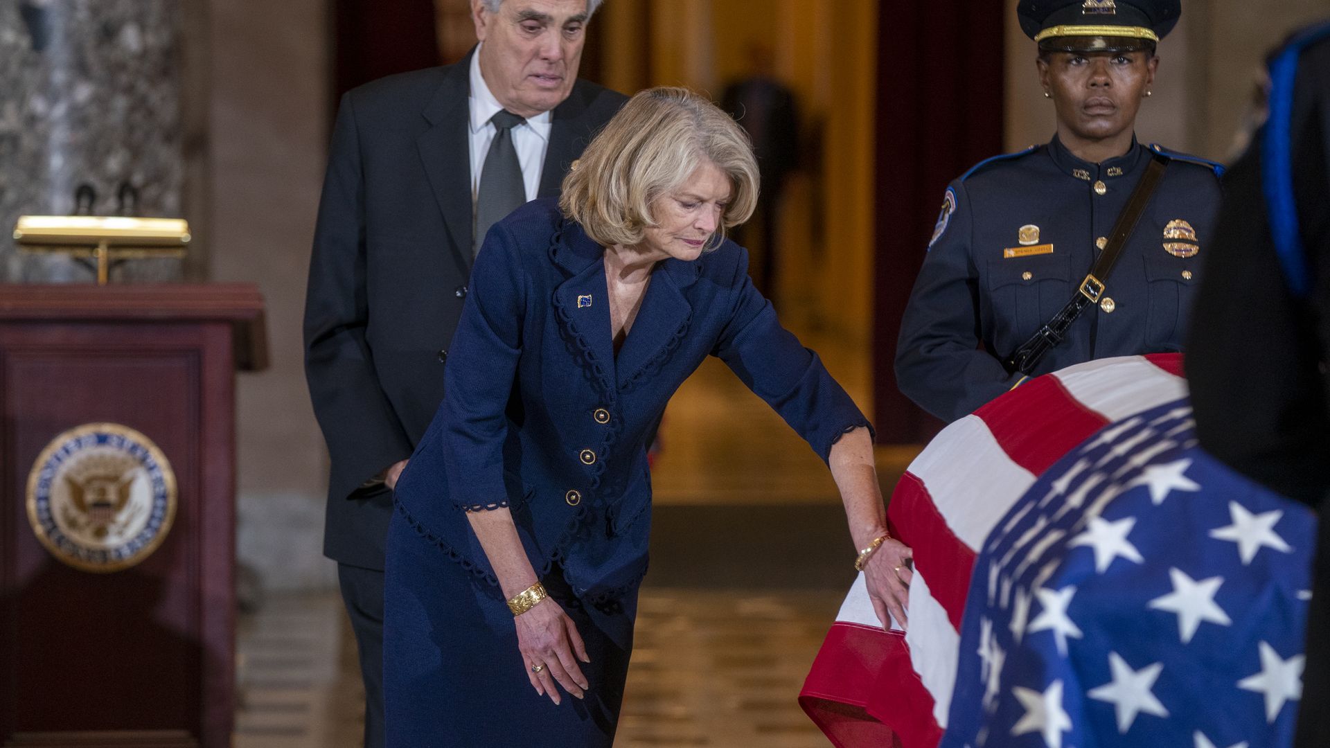 Sen. Lisa Murkowski is seen touching the casket of her late colleague, Rep. Don Young.