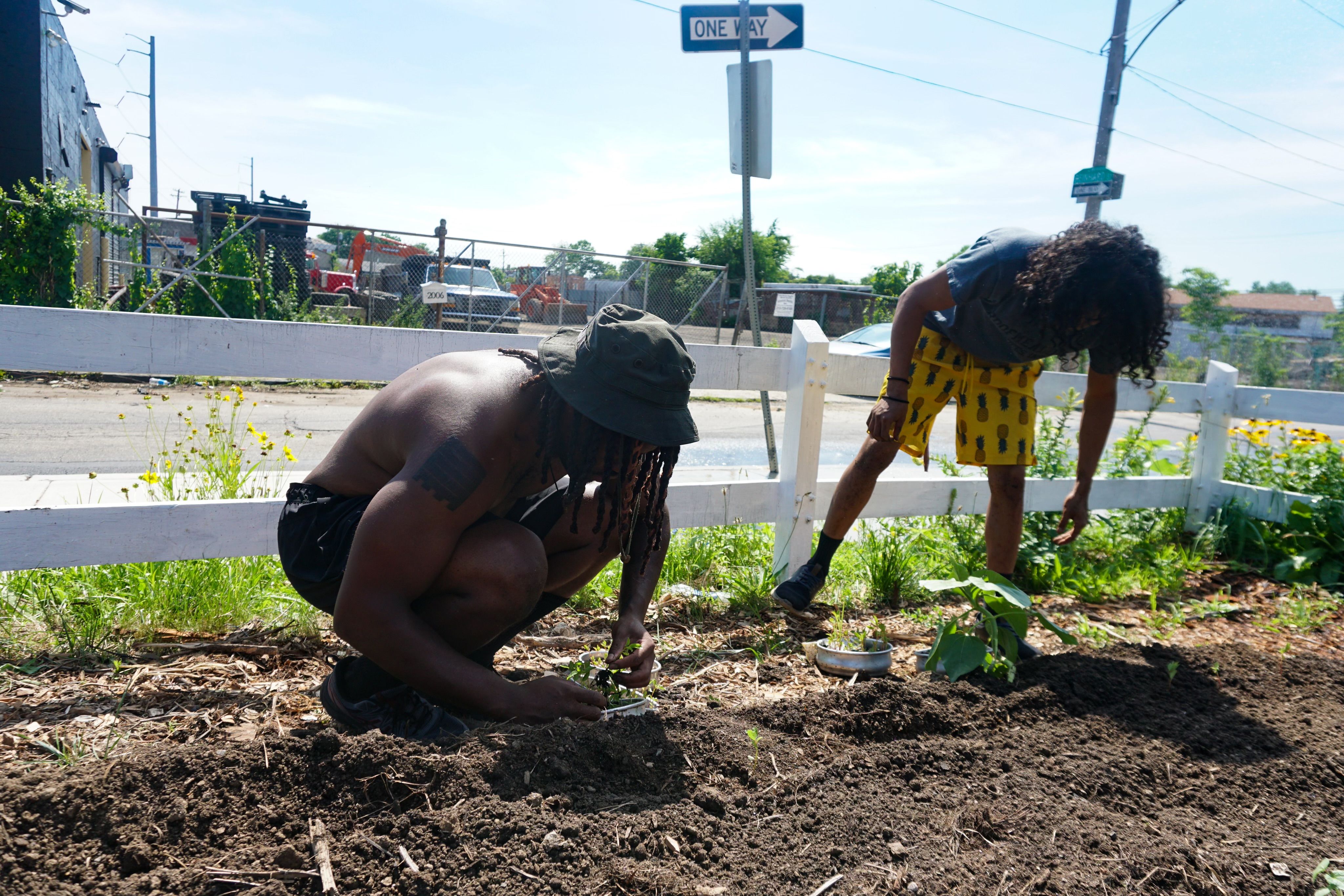 Two young boys plant in a community garden in Southwest Philadelphia.