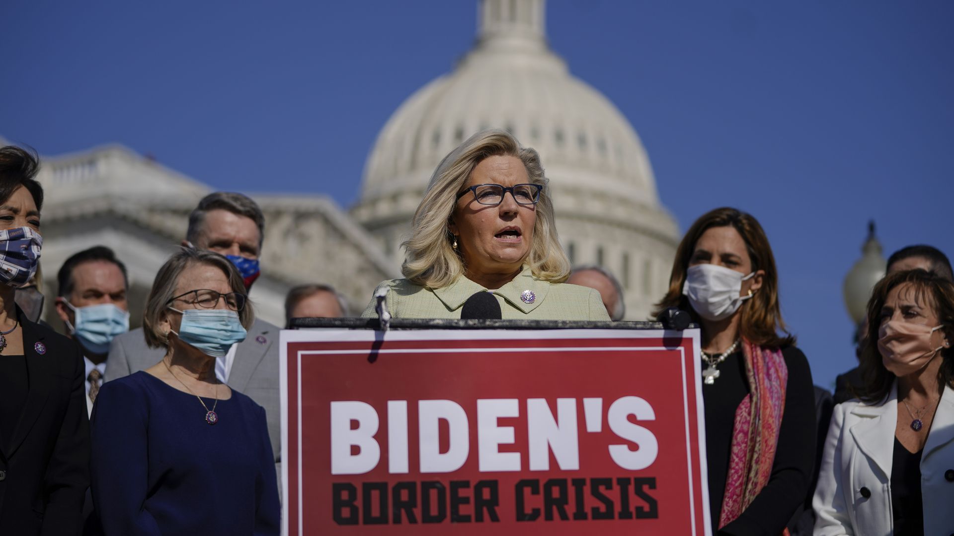 Rep. Liz Cheney is seen standing in front of the Capitol during a news conference focused on the southern border crisis.