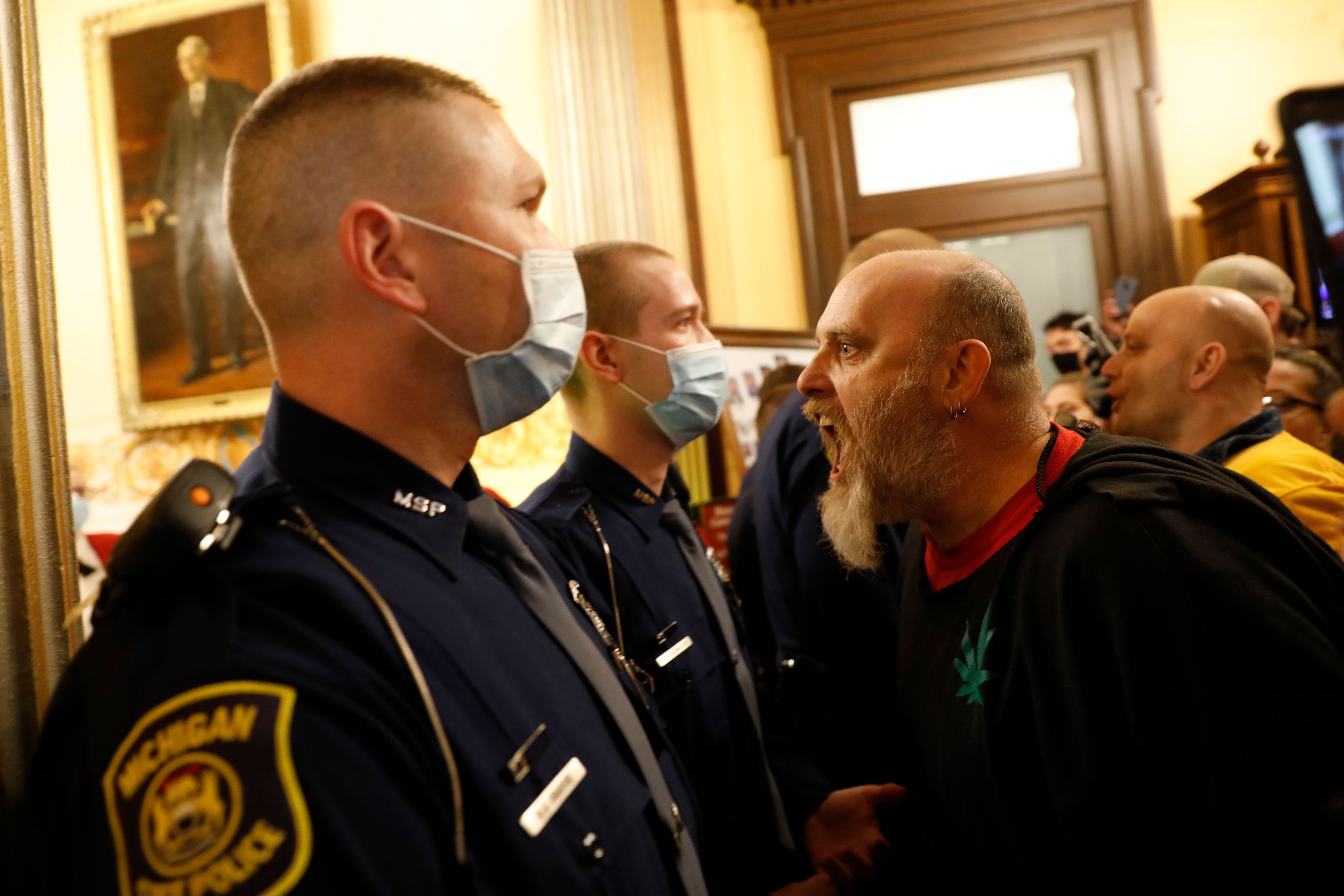 Protestors try to enter the Michigan House of Representative chamber and are being kept out by the Michigan State Police