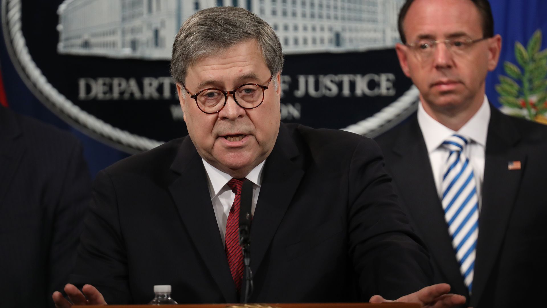 William Barr at . press conference. Rod Rosenstein is behind him