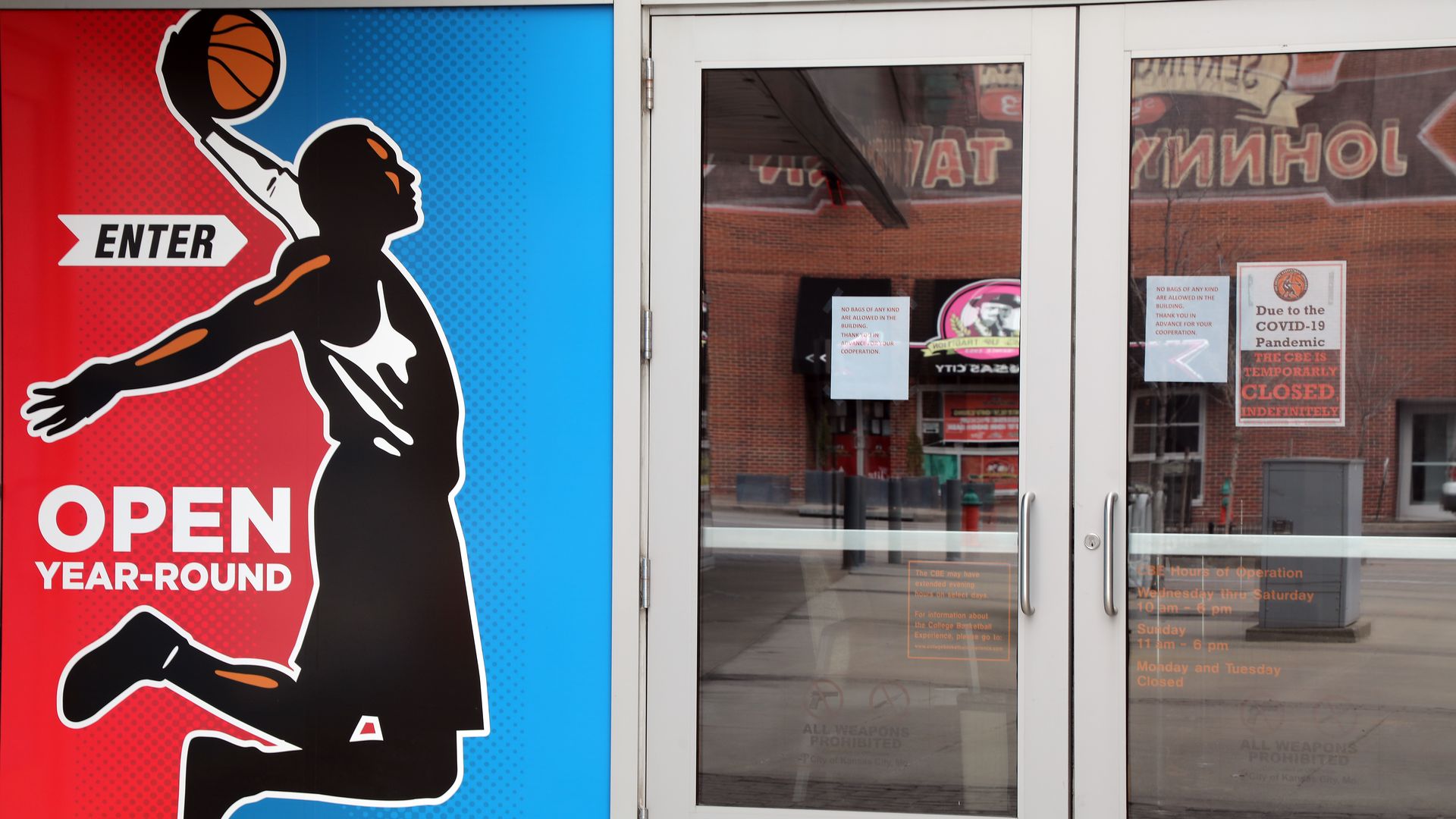 A poster of a man dunking a basketball next to two glass doors