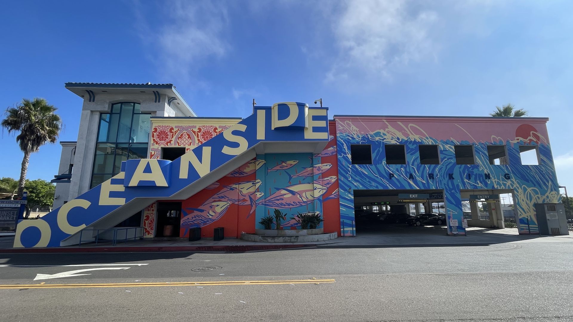 A colorful mural that says OCEANSIDE painted on a parking structure. 