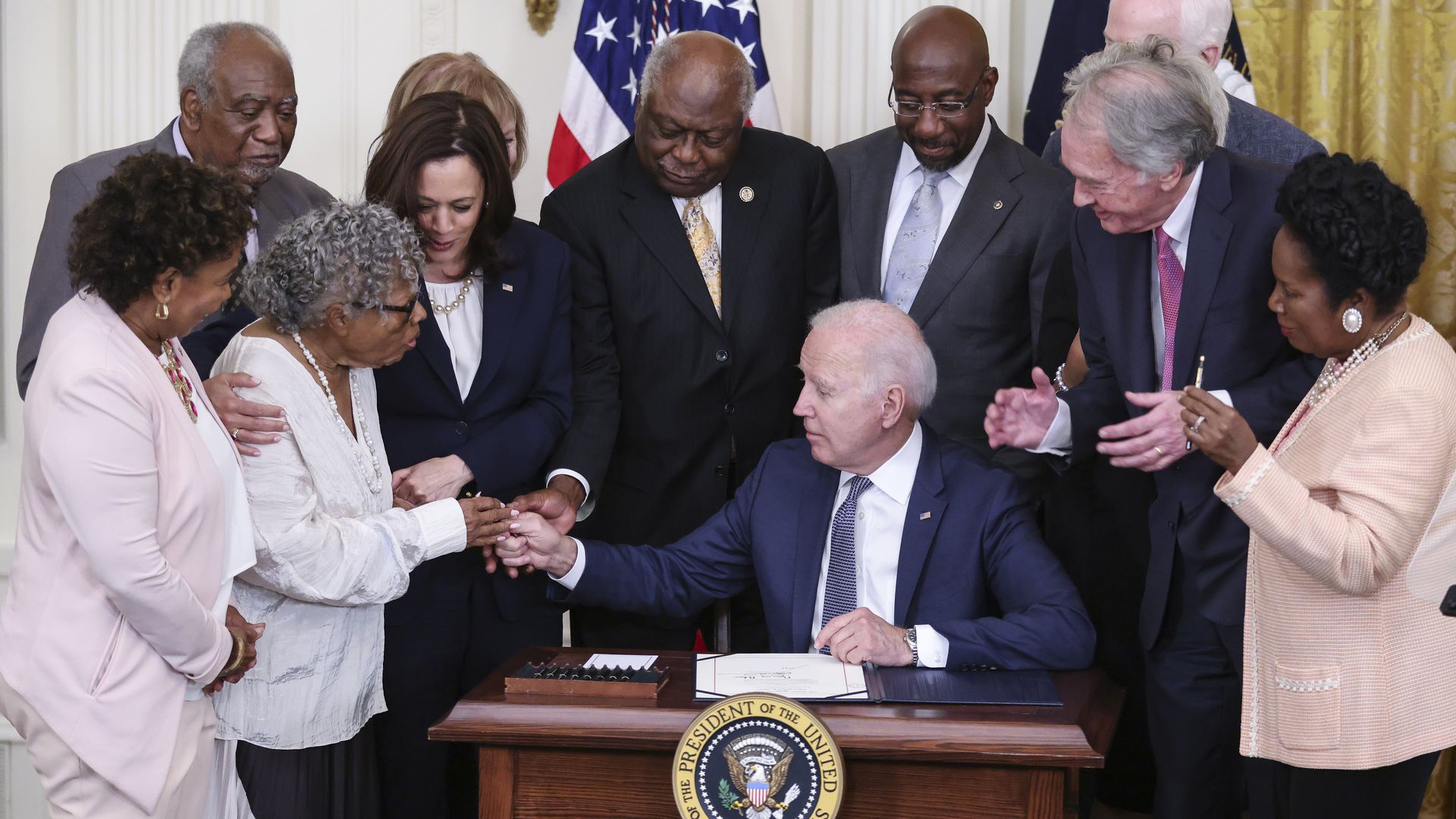 President Biden is seen handing a pen to Opal Lee, the so-called "Grandmother of Juneteenth," after he signed a bill making that occasion a federal holiday.