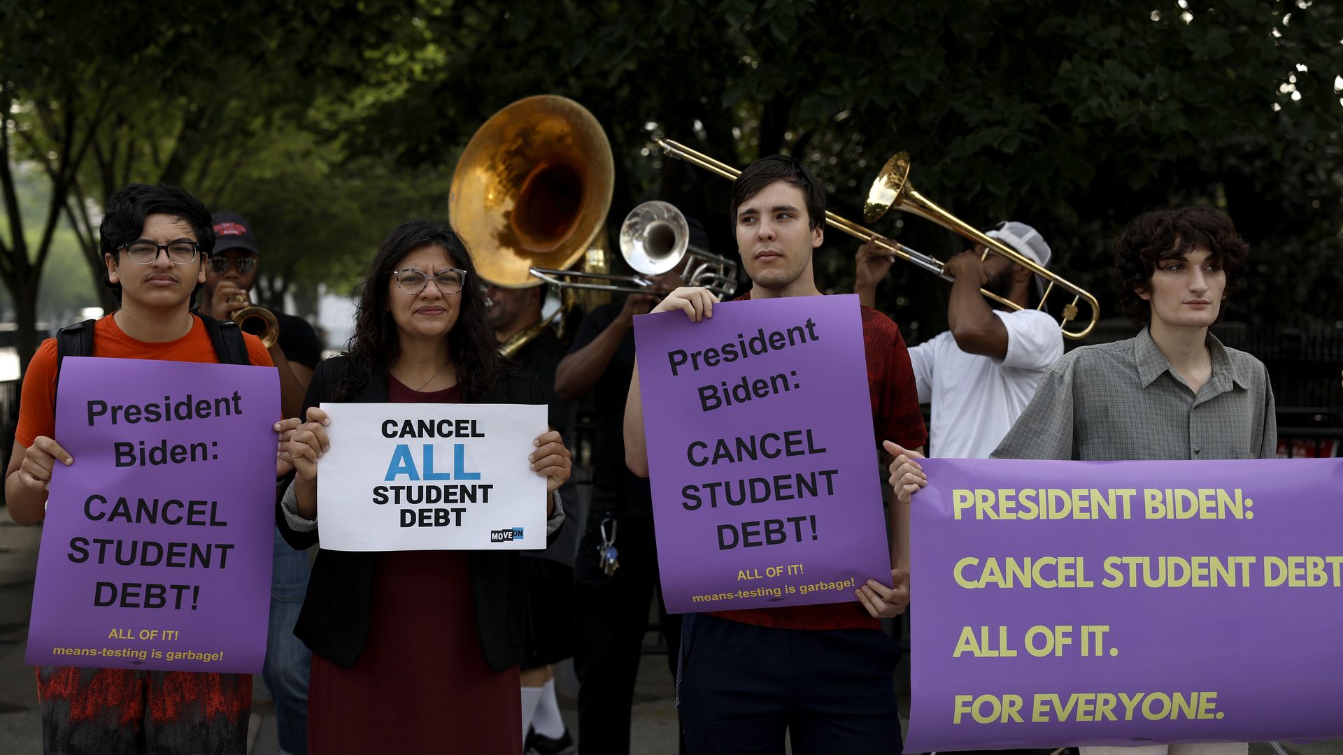 Rep. Rashida Tlaib (R-MI) (2nd from L) attends a rally outside of the White House to call on U.S. President Joe Biden to cancel student debt on July 27, 2022 