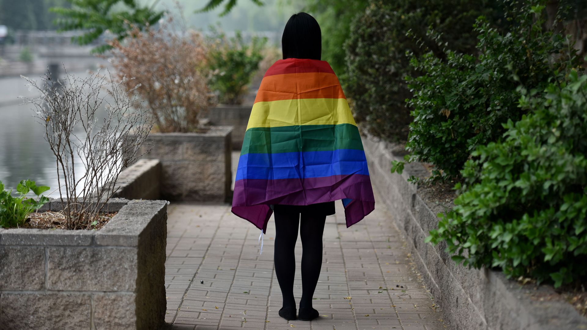 A gay student poses with a rainbow flag in Beijing in 2019.