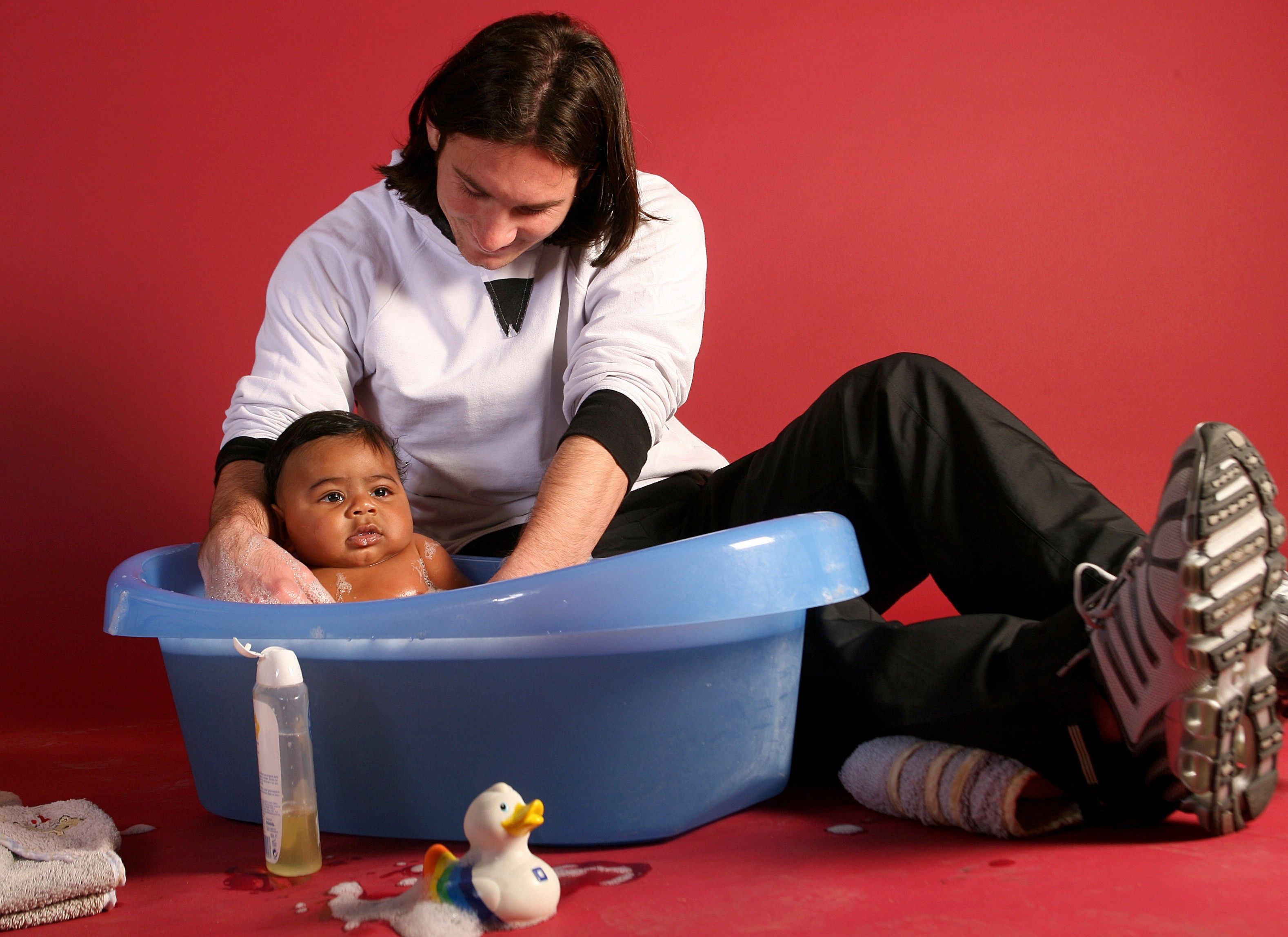 20-year-old soccer star Lionel Messi helps to bathe Lamine Yamal, who was merely six months old at the time, during a photo session in Sept. 2007 in the dressing room of the Camp Nou stadium in Barcelona, Spain. (AP Photo/Joan Monfort)