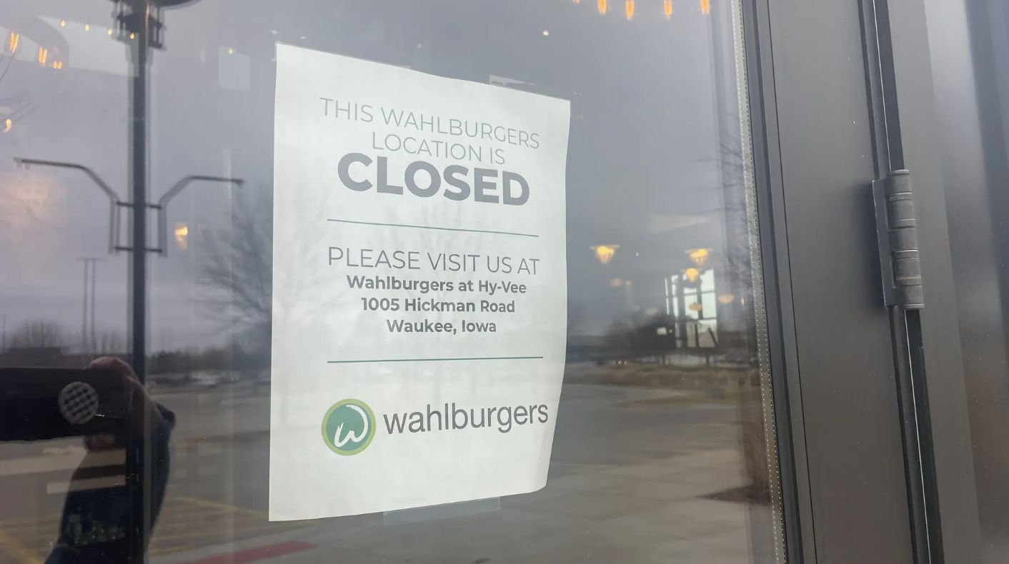 Wahlburger's closed sign saying visit the Waukee Hickman Hy-Vee instead