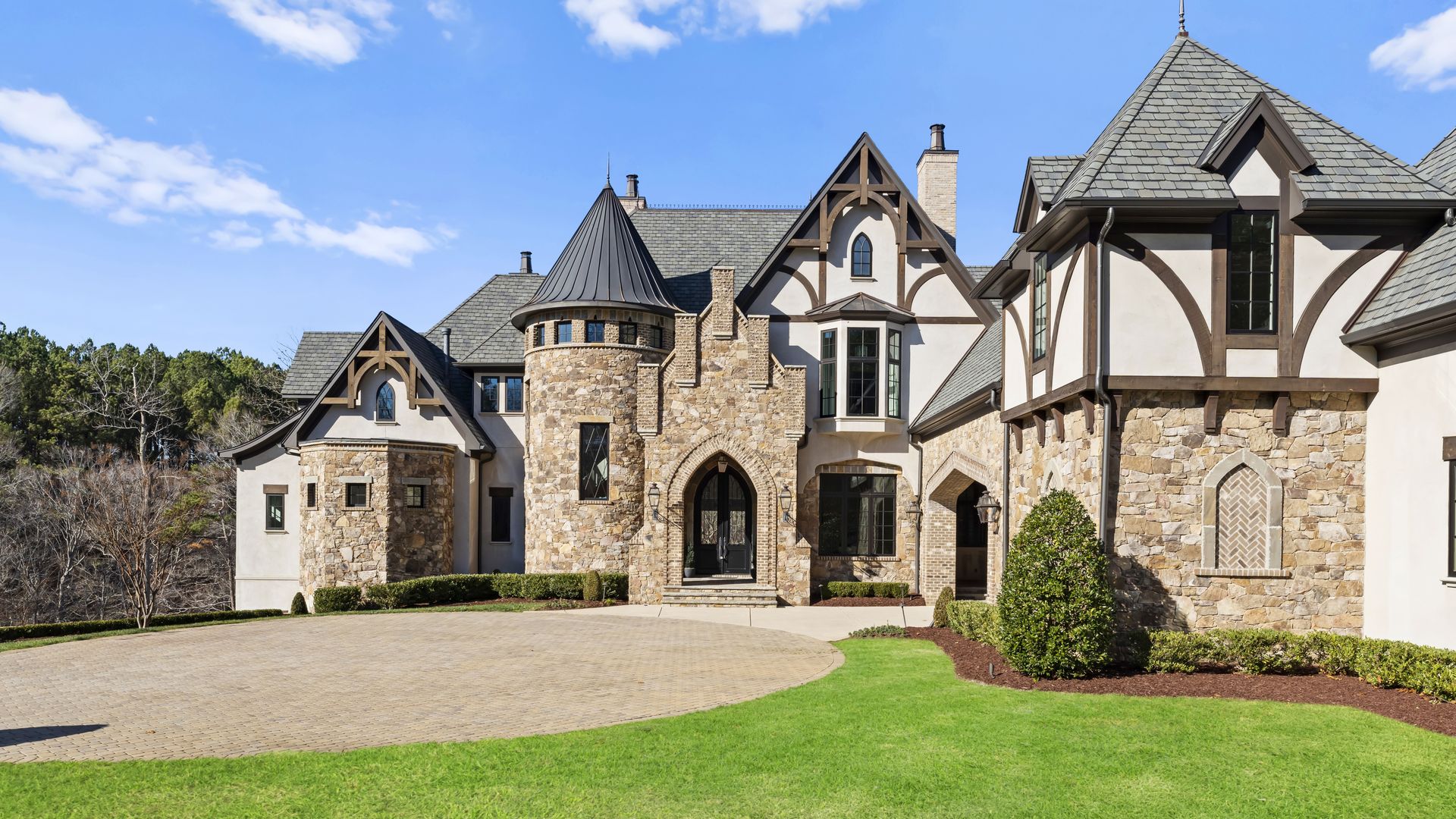 stone mansion with turrets and pitched rooflines