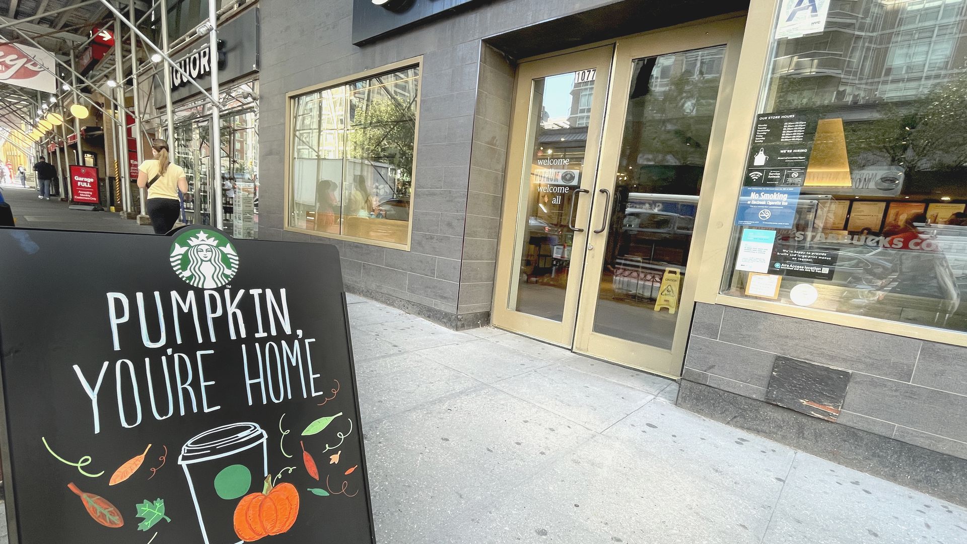 Sign that says "Pumpkin, you're home" in front of a Starbucks store front.