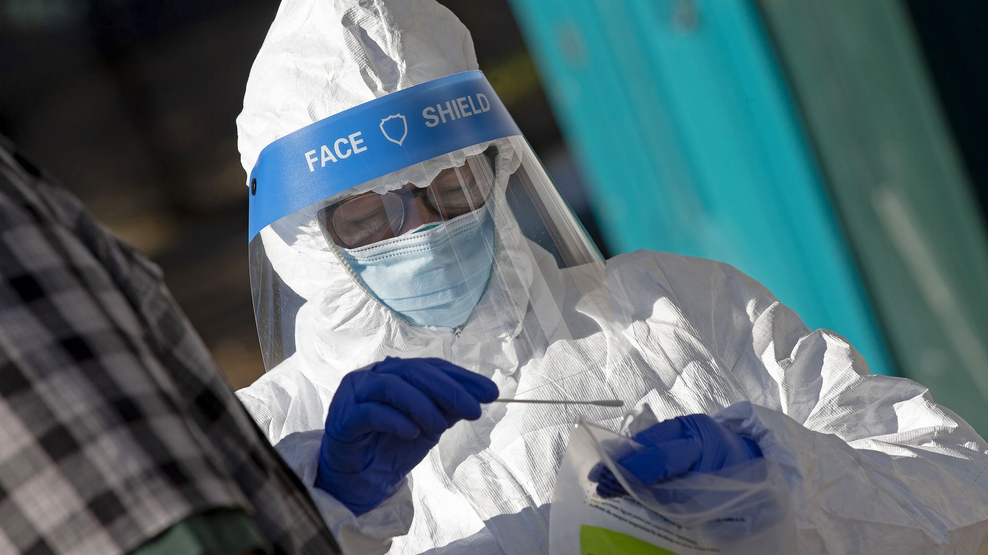 A health worker handling a coronavirus test sample Oct. 15 in Roxbury, Massachusetts