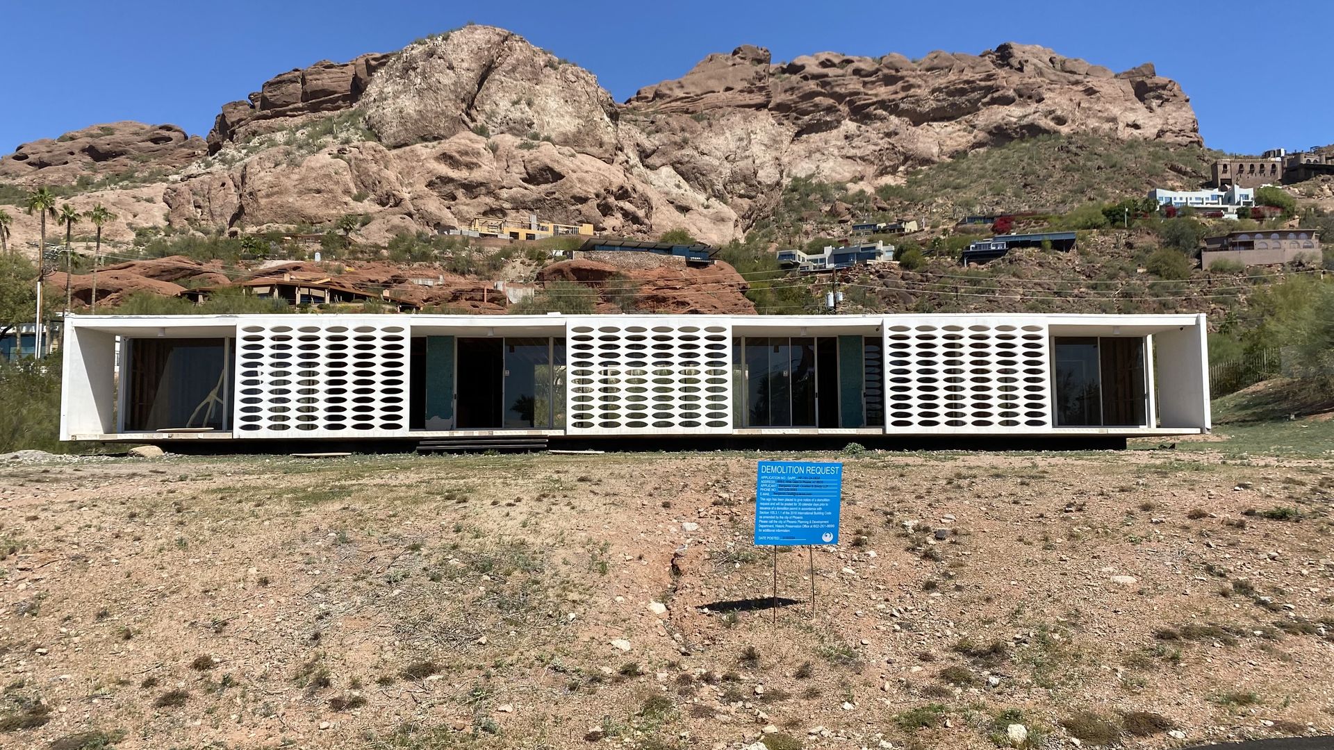 A midcentury modern home up against a mountain. 