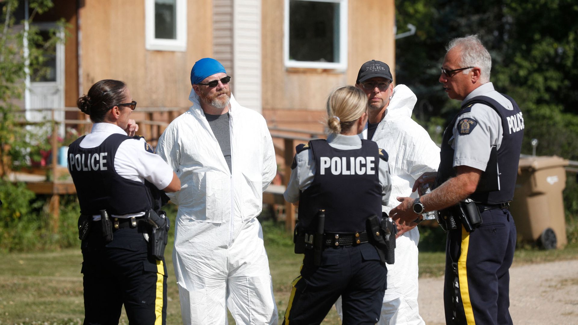 Royal Canadian Mounted Police forensics officers speak outside the crime scene where stabbing victim Wes Petterson was found, in Weldon, Saskatchewan, Canada, on September 7.