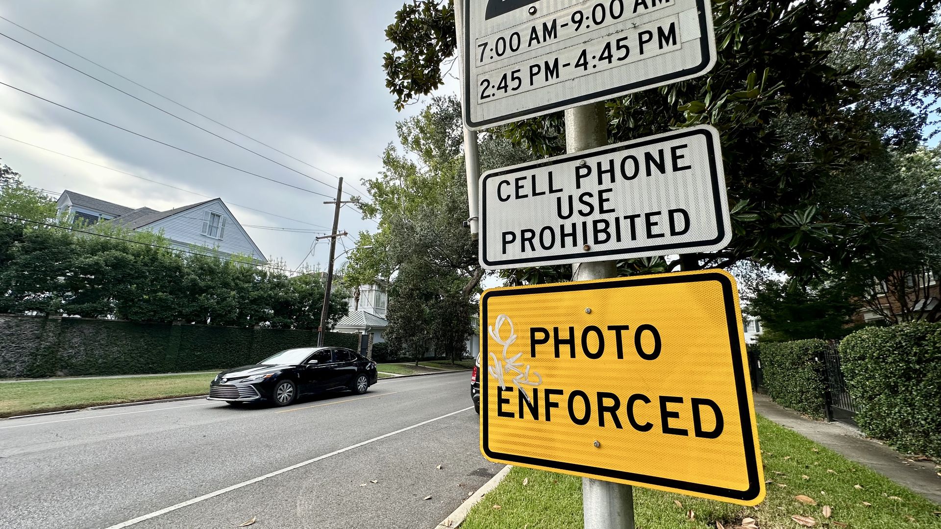 Photo shows a school zone sign that says "photo enforced"