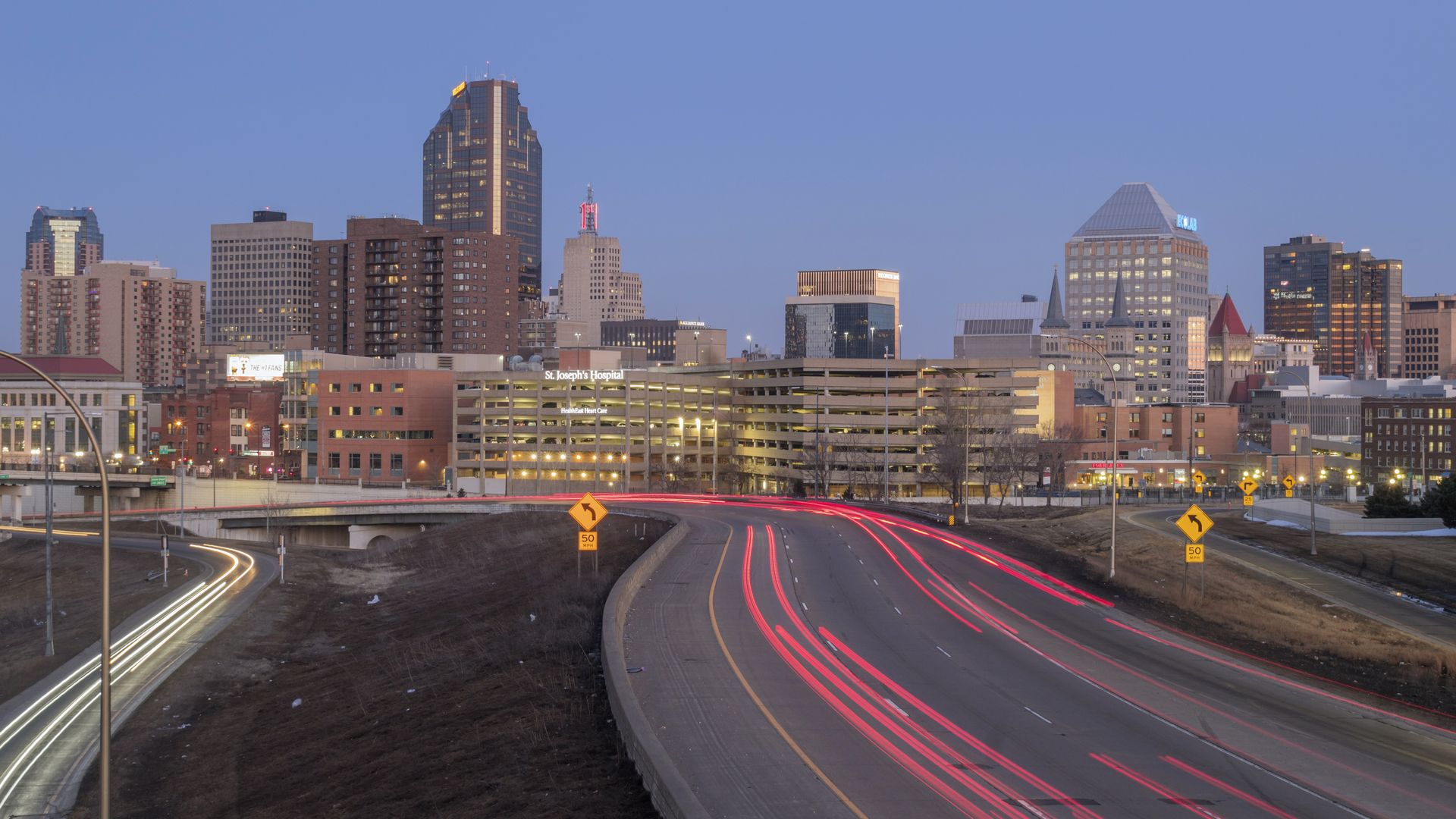 The downtown skyline with traffic in the foreground