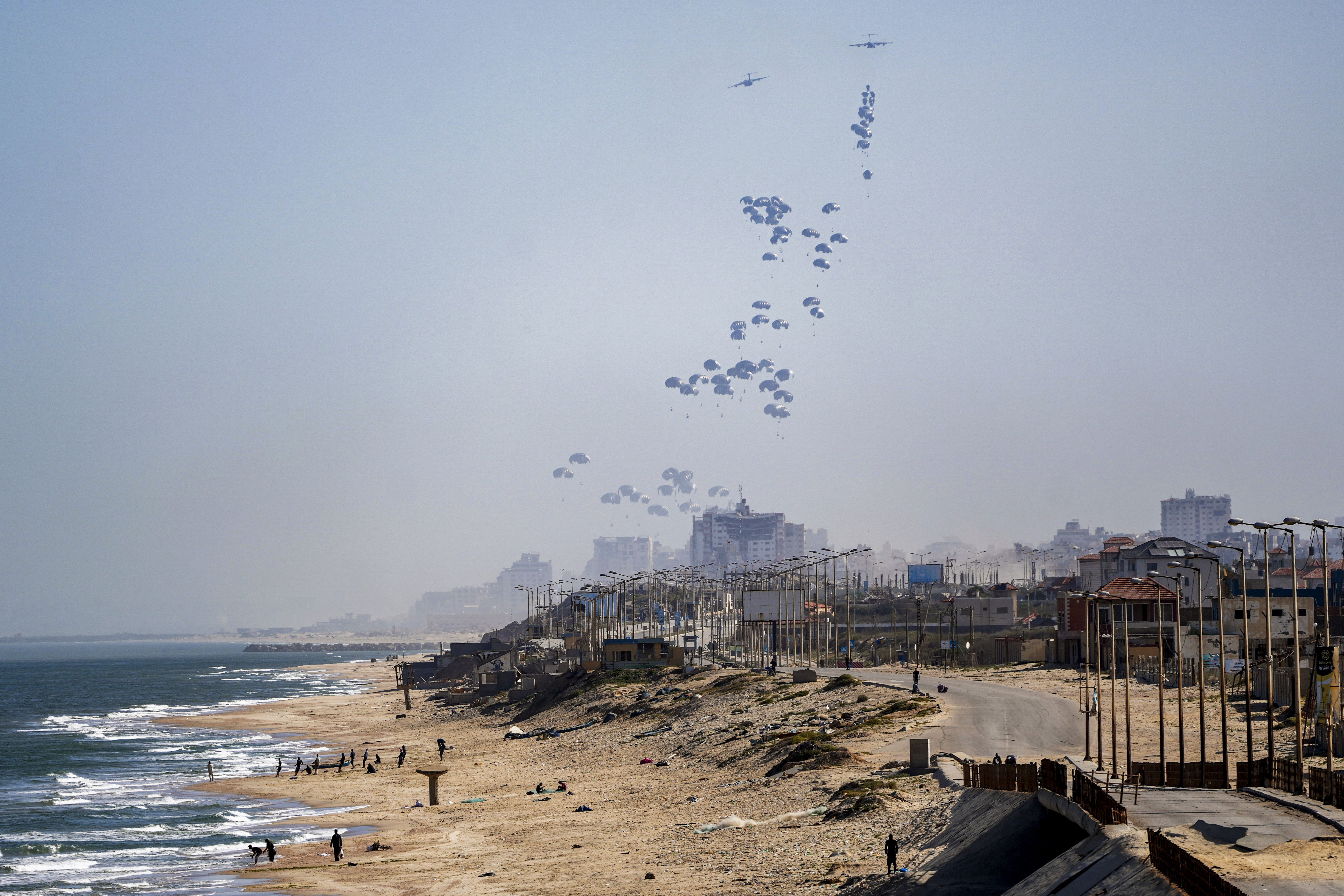 An aircraft airdrops humanitarian aid over the northern Gaza Strip yesterday.