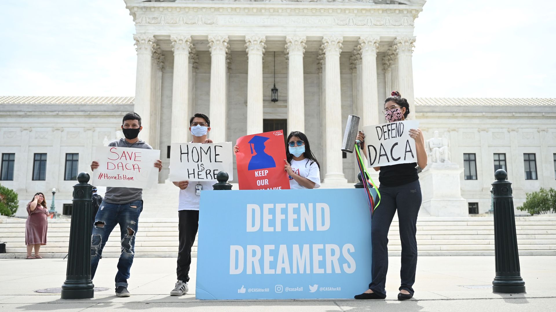 Protesters hold a sign that reads Defend Dreamers