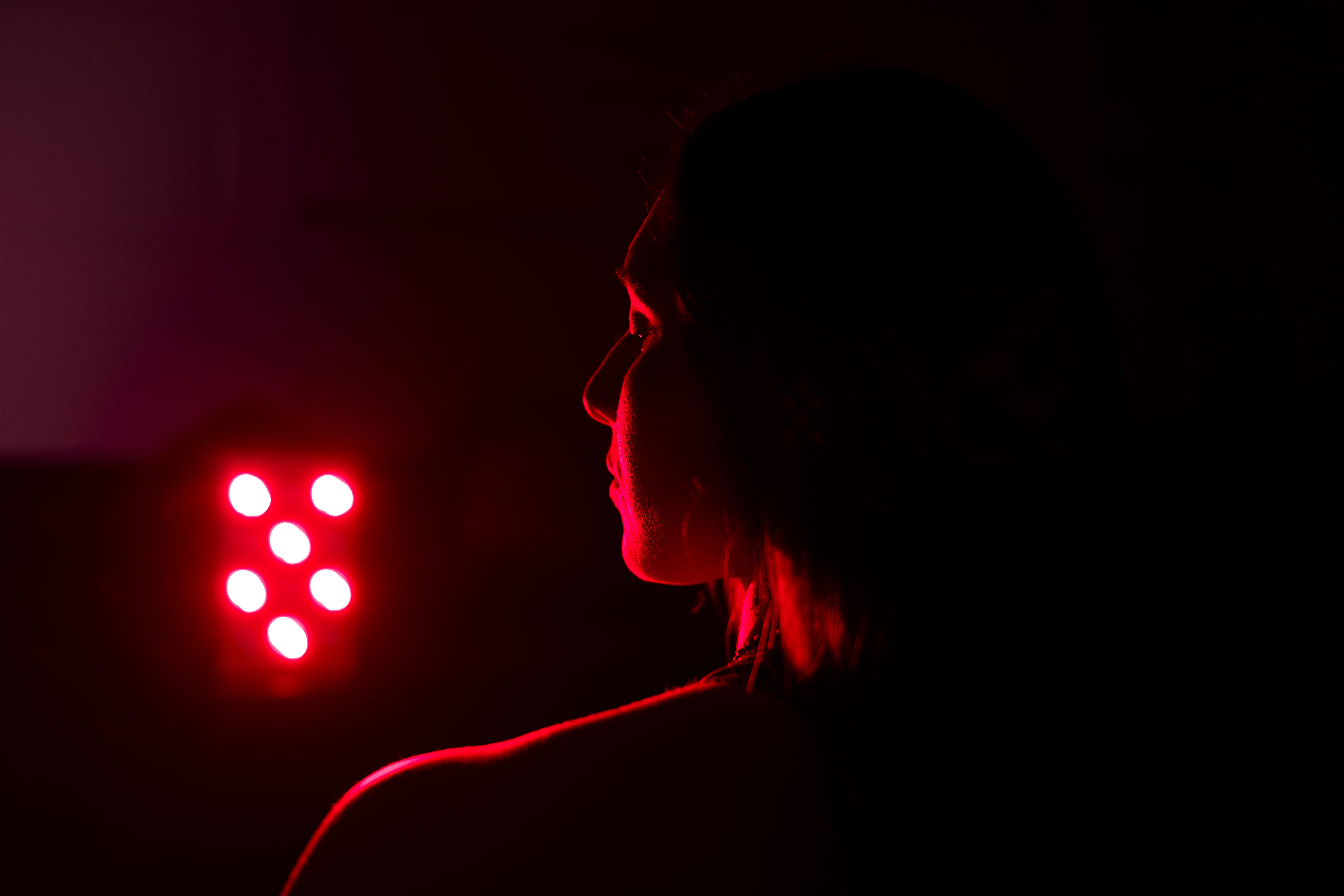 A women stands in red light