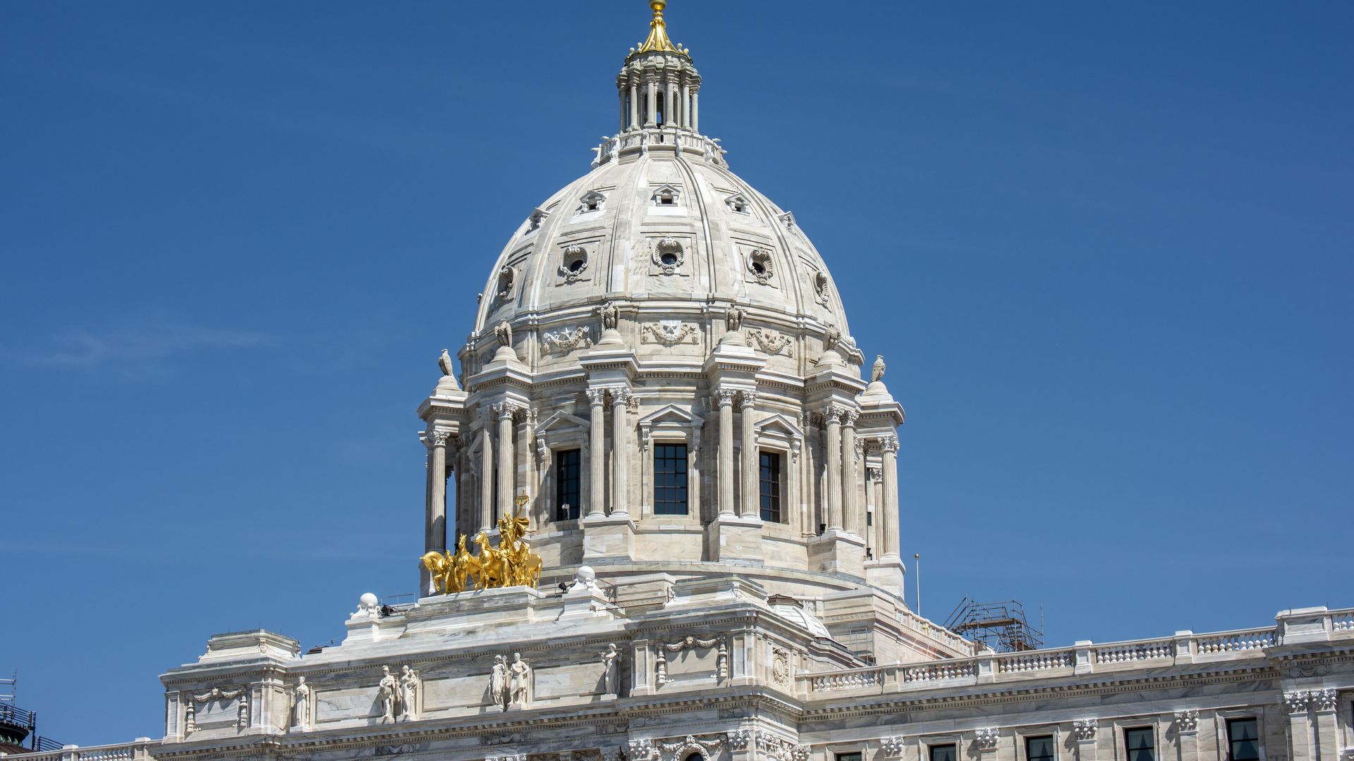 white minneosta capitol dome exterior against a blue sign