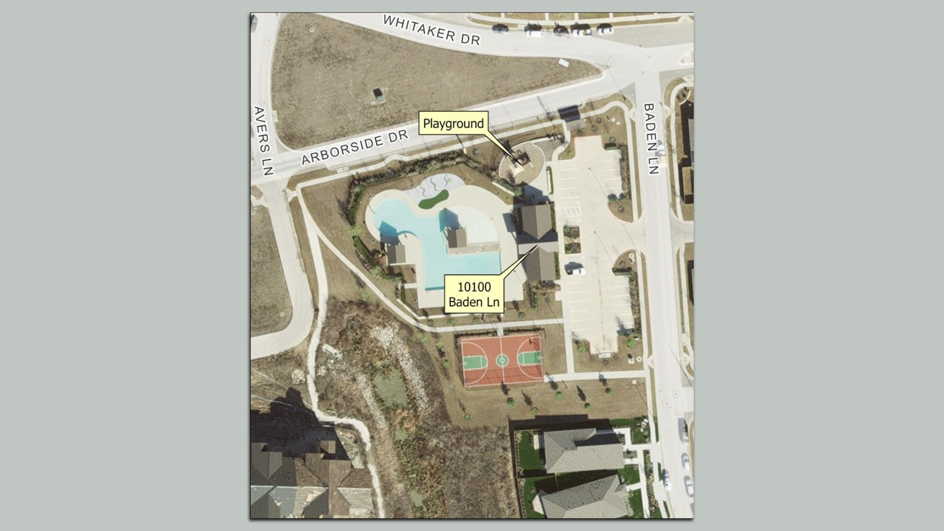 Aerial view of a residential complex with a curved blue pool, a playground, parking lots, and buildings. Roads Arborside Dr, Whitaker Dr, Baden Ln; labels show "Playground" and "10100 Baden Ln".