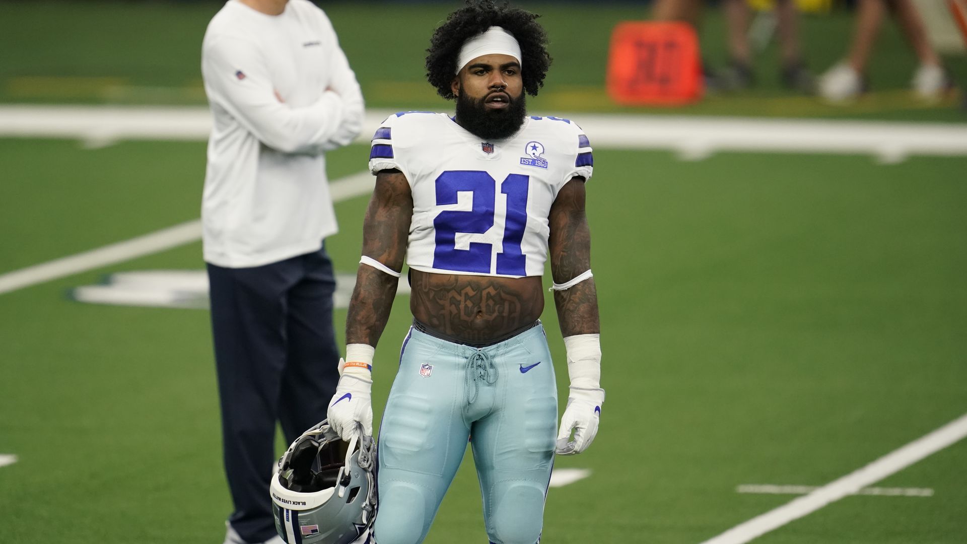 Ezekiel Elliott in 2020 wearing a Cowboys uniform with a crop top