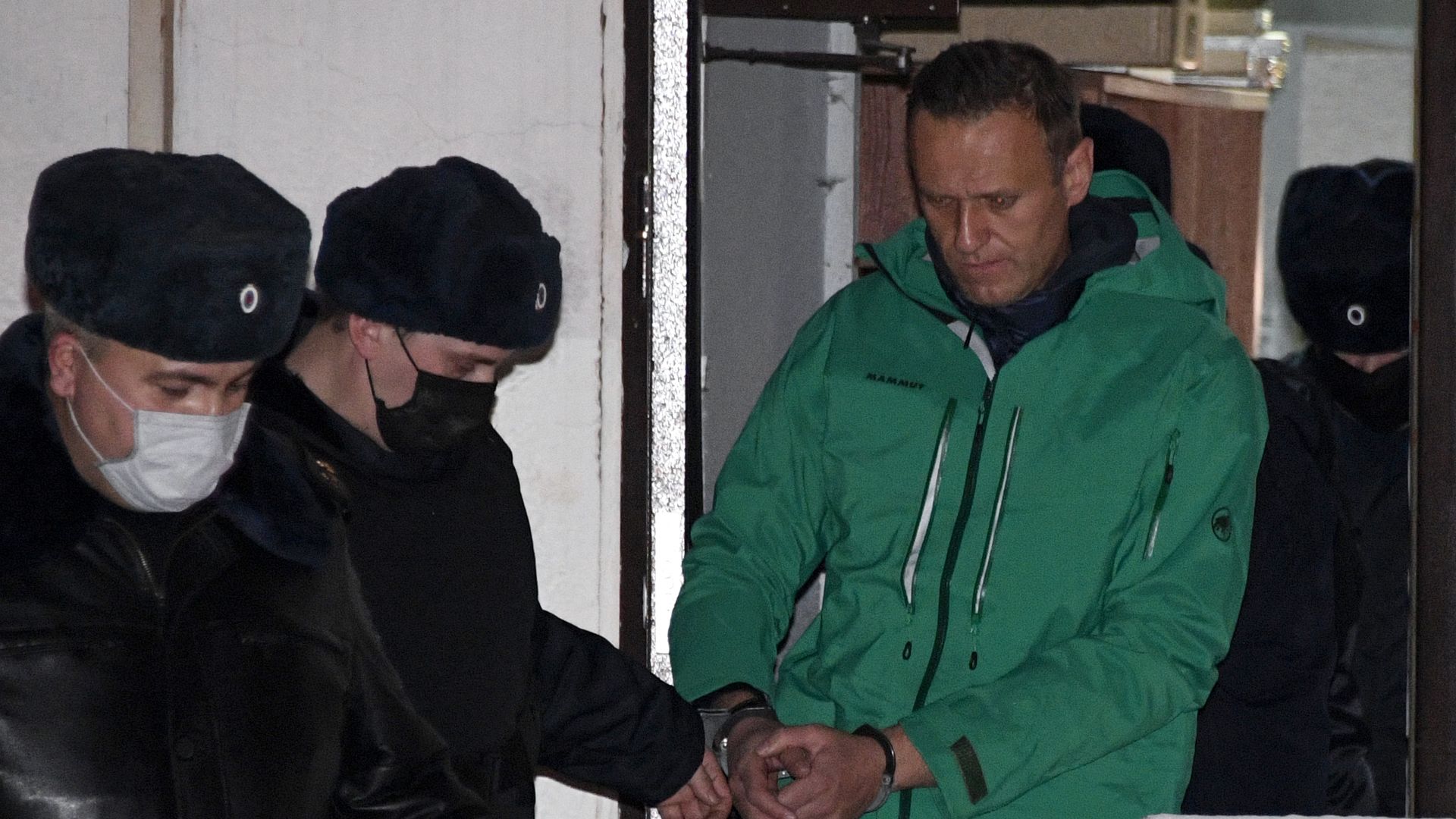 Opposition leader Alexei Navalny is escorted out of a police station on January 18, 2021, in Khimki, outside Moscow.