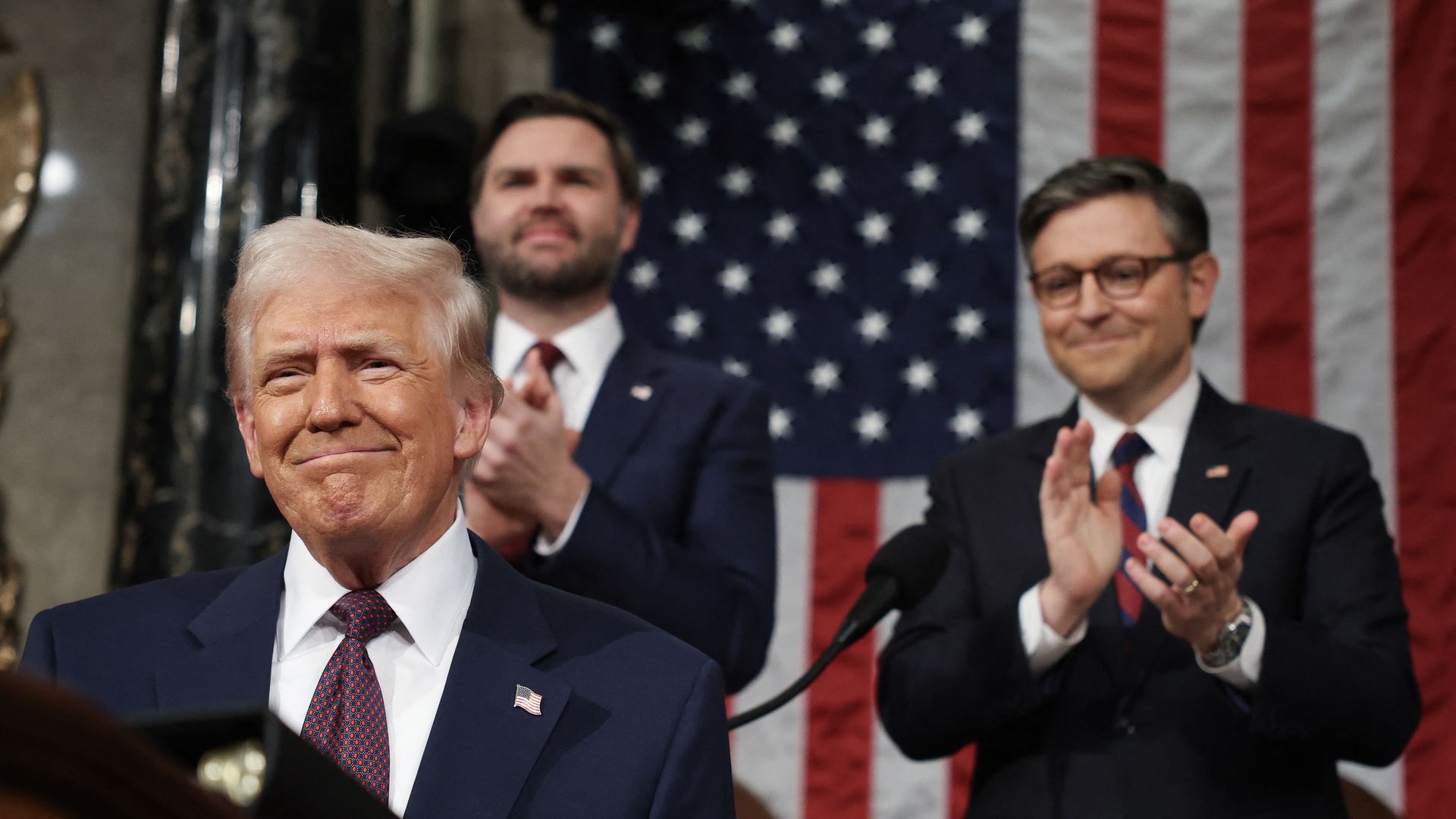 US Speaker of the House Mike Johnson (R-LA) and Vice President JD Vance applaud as US President Donald Trump arrives to address a joint session of Congress at the US Capitol in Washington, DC, on March 4, 2025. (Photo by Win McNamee / AFP) (Photo by WIN MCNAMEE/AFP via Getty Images)