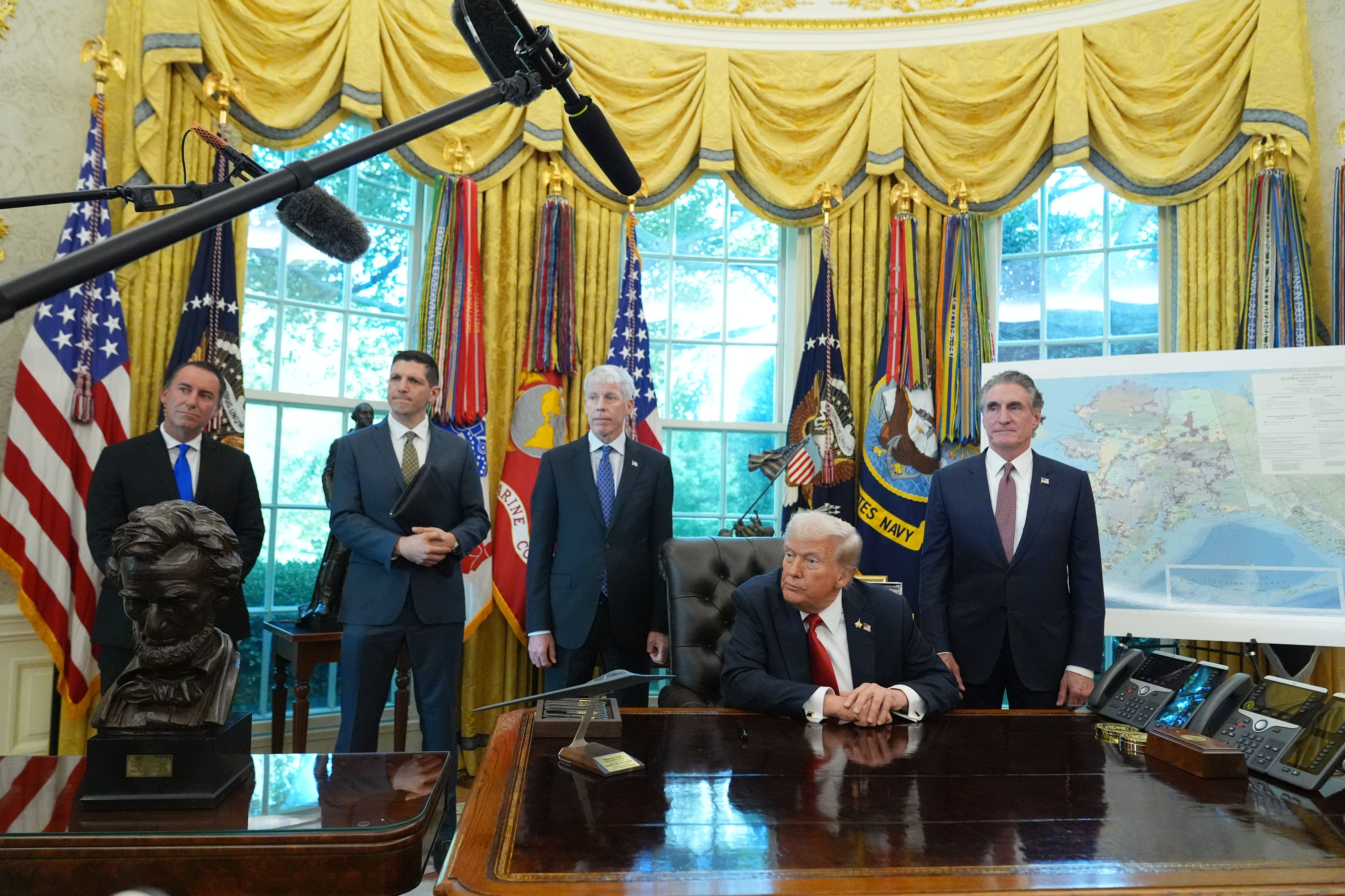 President Donald Trump speaks to reporters before signing an executive order in the Oval Office at the White House, Monday, Oct. 6, 2025, in Washington. (AP Photo/Jacquelyn Martin)
