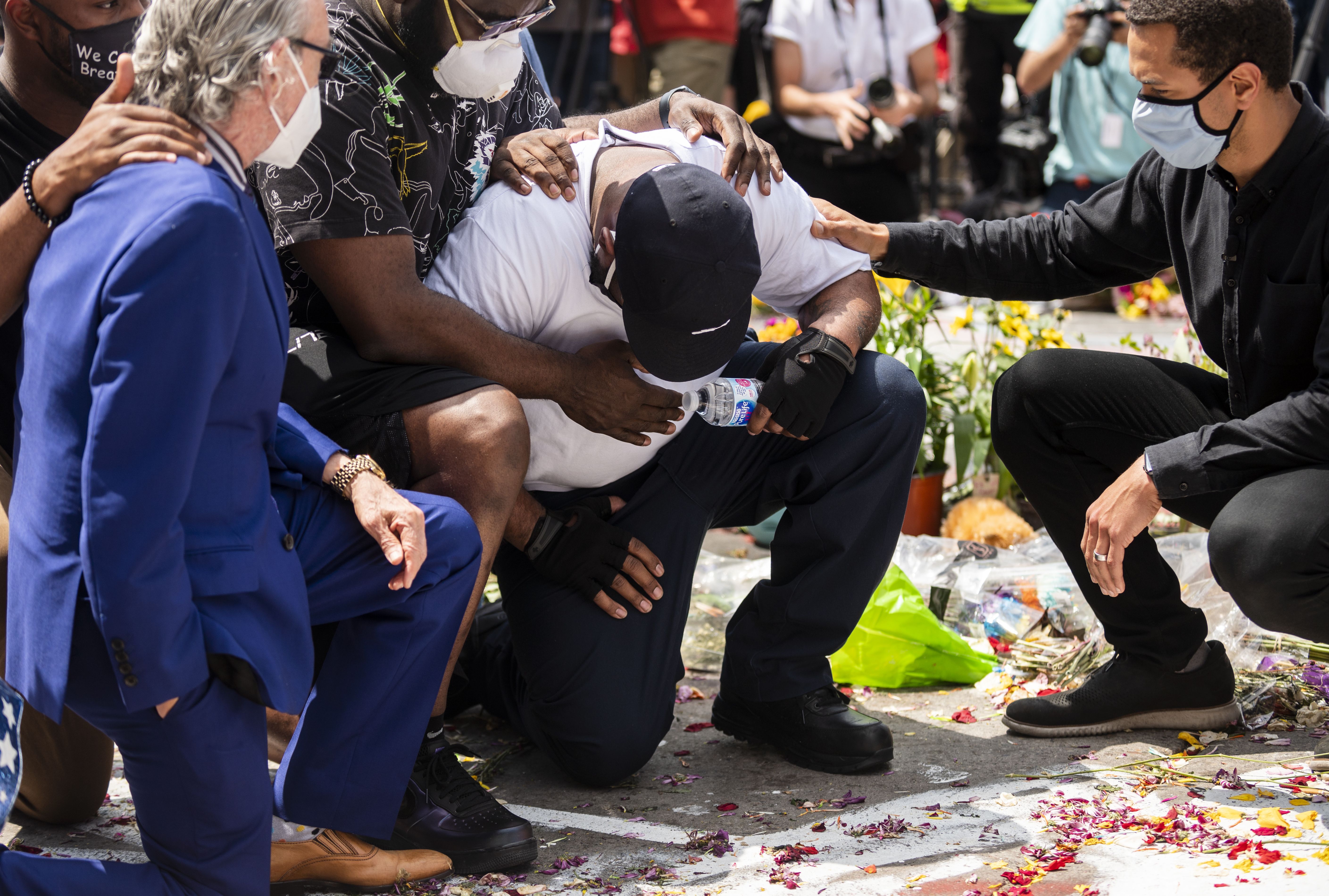 errence Floyd (C) falls to his knees at the site where his brother George Floyd was killed by police one week ago on June 1, 2020 in Minneapolis, Minnesota.