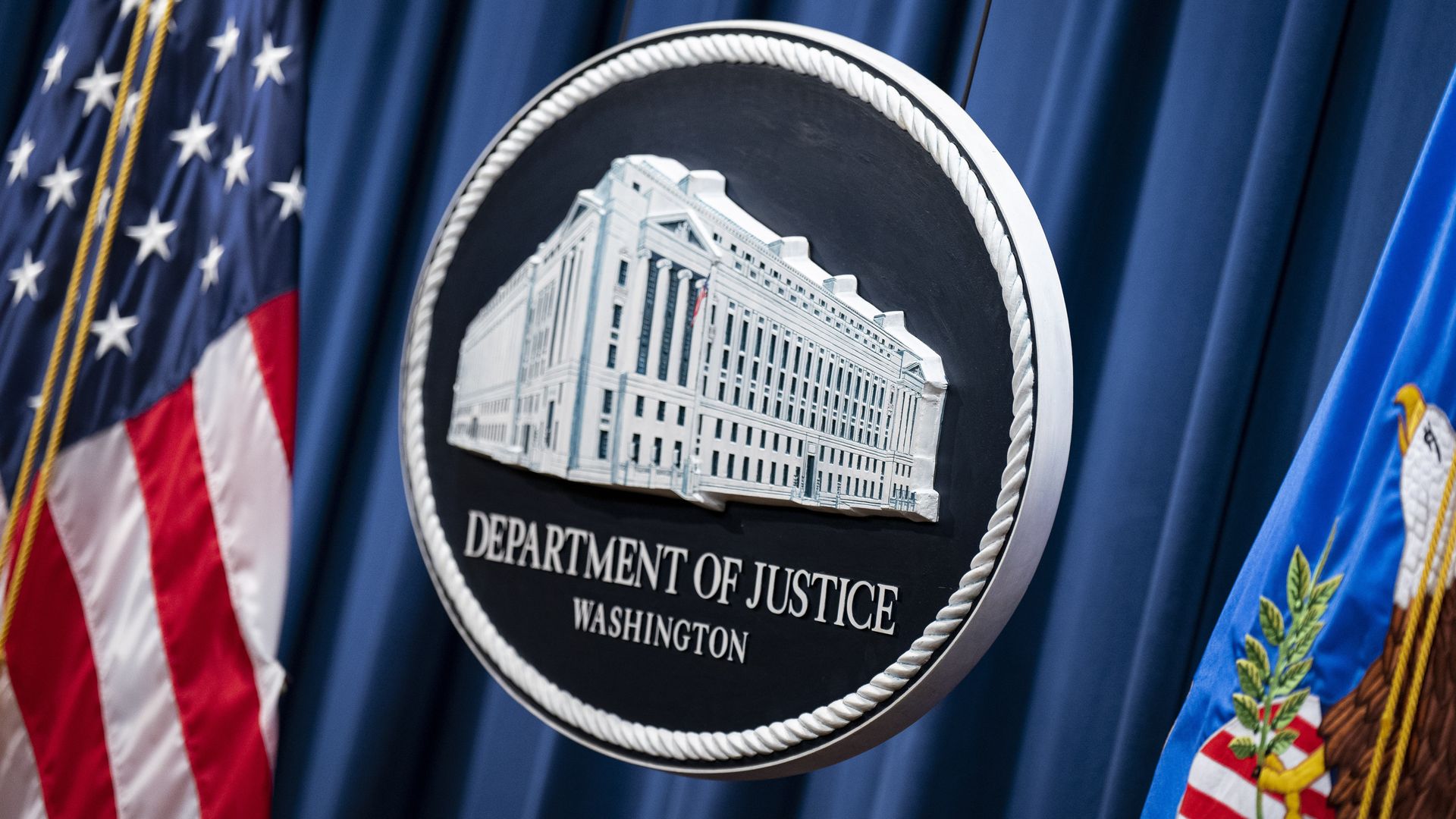 The Department of Justice seal. 