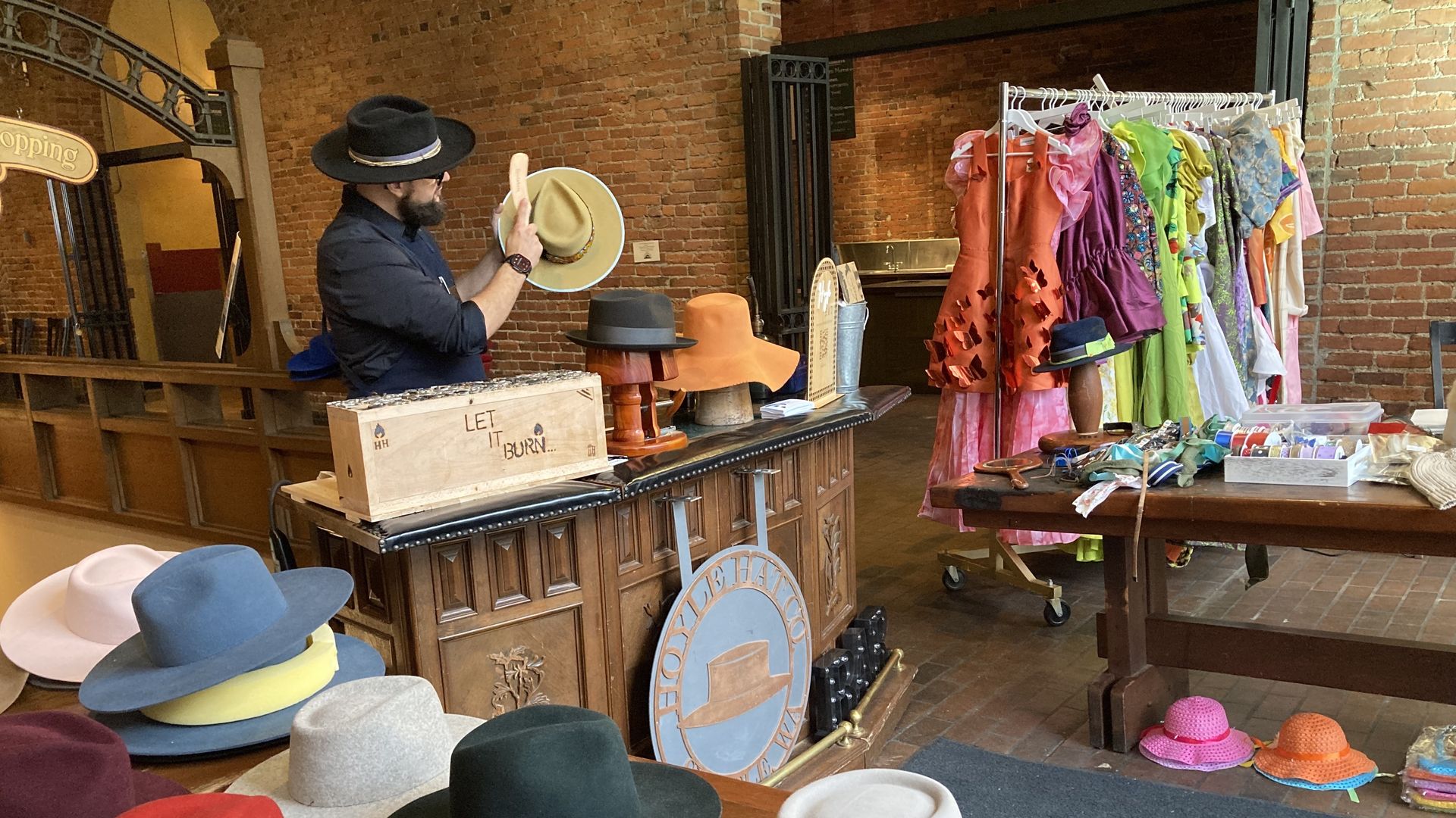 A hat-maker brushes a custom creation at a pop-up hat bar in Pioneer Square. 