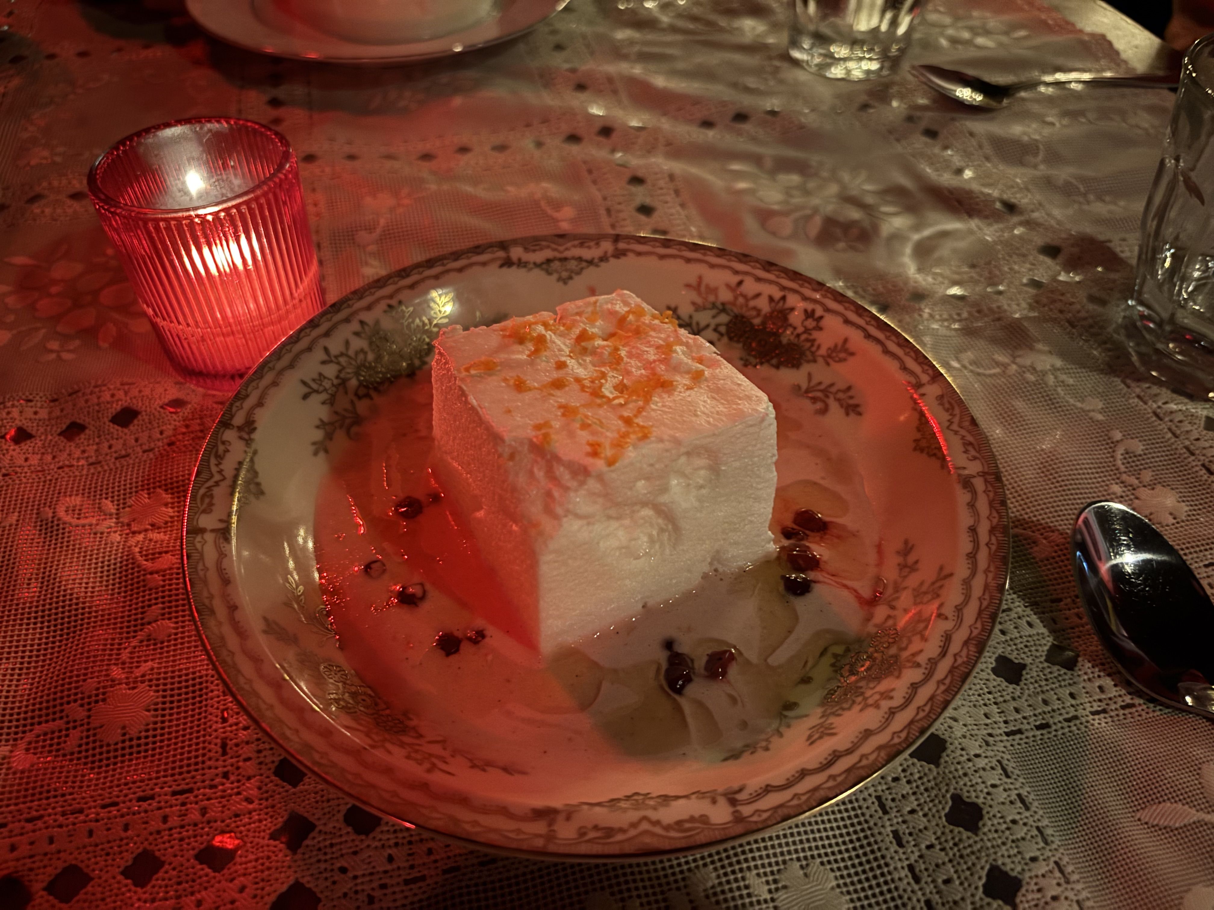 Fet Fisk's floating island dessert hovering on a pool of rich brown butter and lingonberries