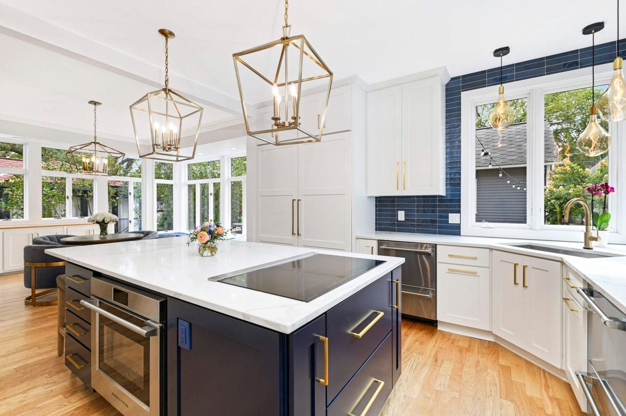 modern kitchen with white cabinets and deep blue accents